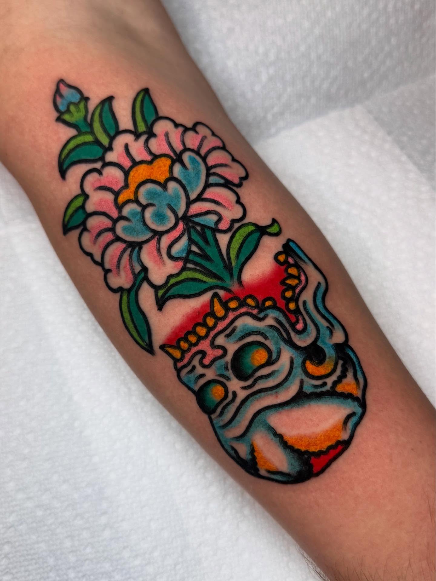 Skull and flowers American traditional tattoo on the forearm by Jonathan Clapp, San Antonio, Texas