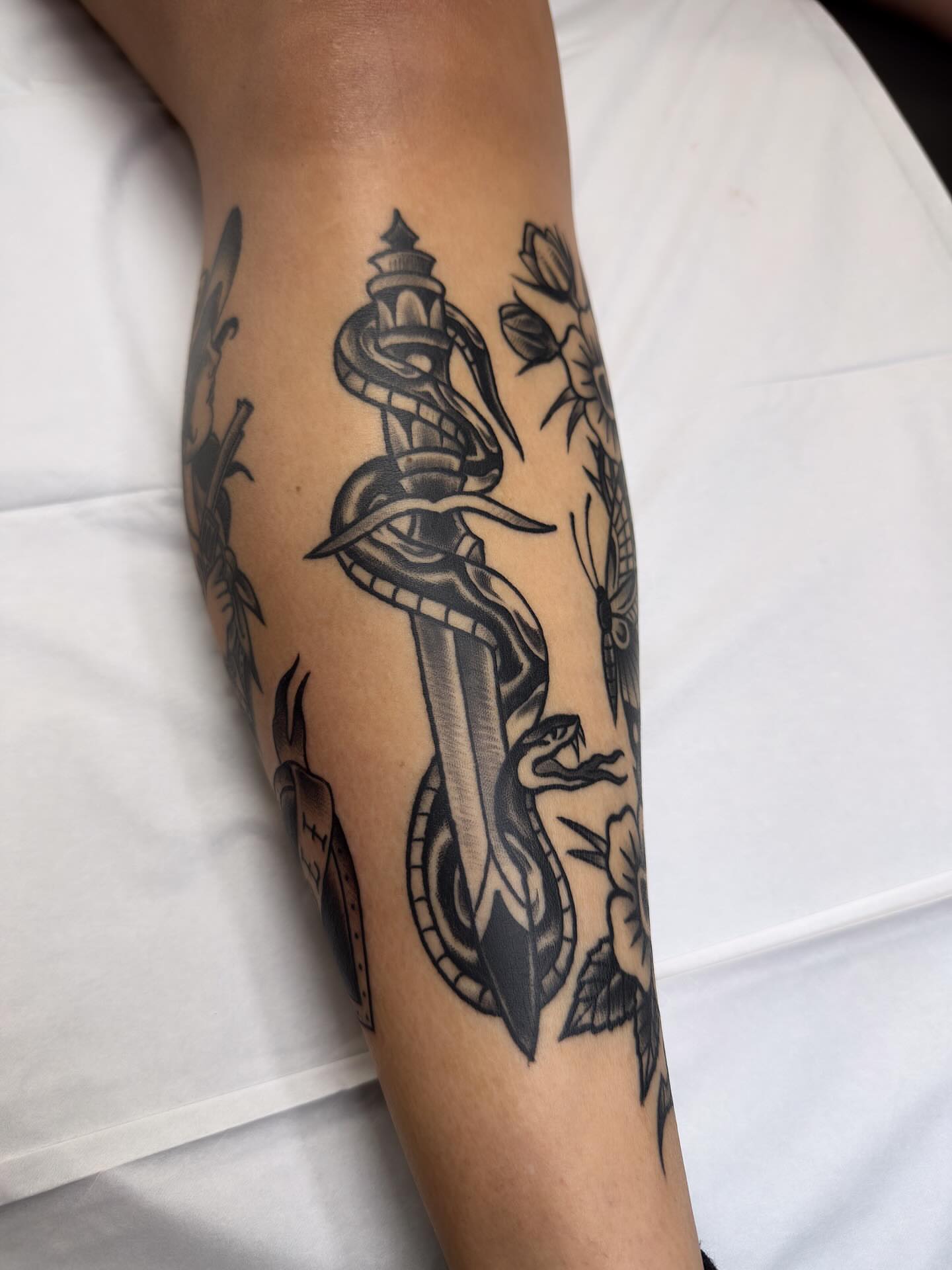Sword and snake American traditional tattoo on the forearm by Trav, Bayville, New Jersey
