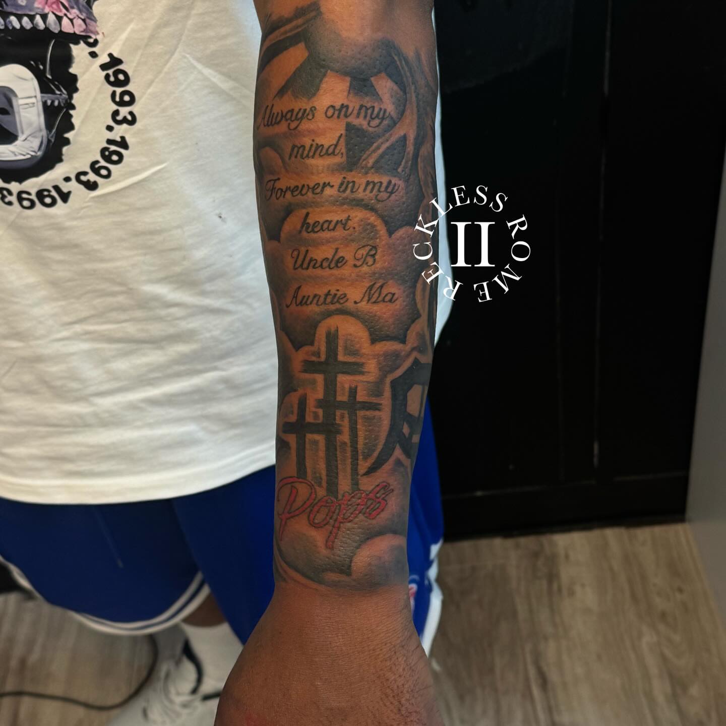 Religious cross black and grey tattoo on the forearm by Rome