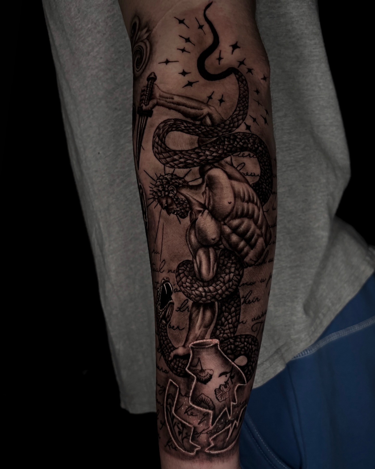 Snake and muscular figure realism tattoo on the forearm by Trev