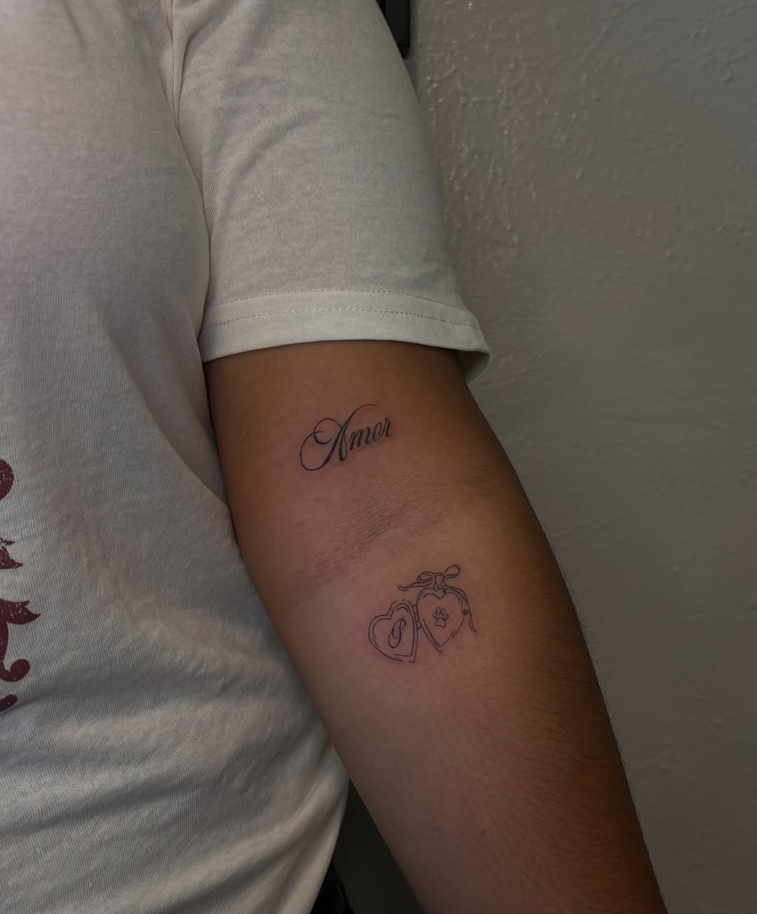 Script lettering and lockets minimalist tattoo on the forearm by Valentina
