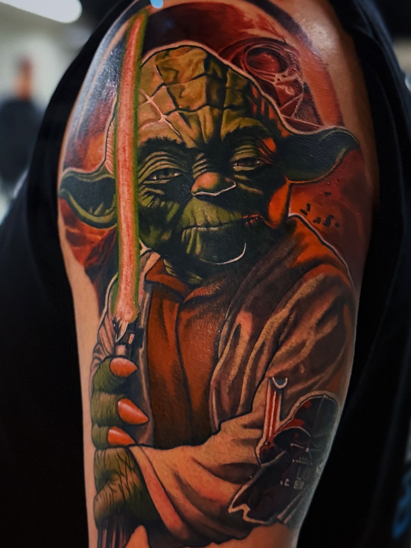 Yoda realism tattoo on the upper arm by Kelsey Zussman