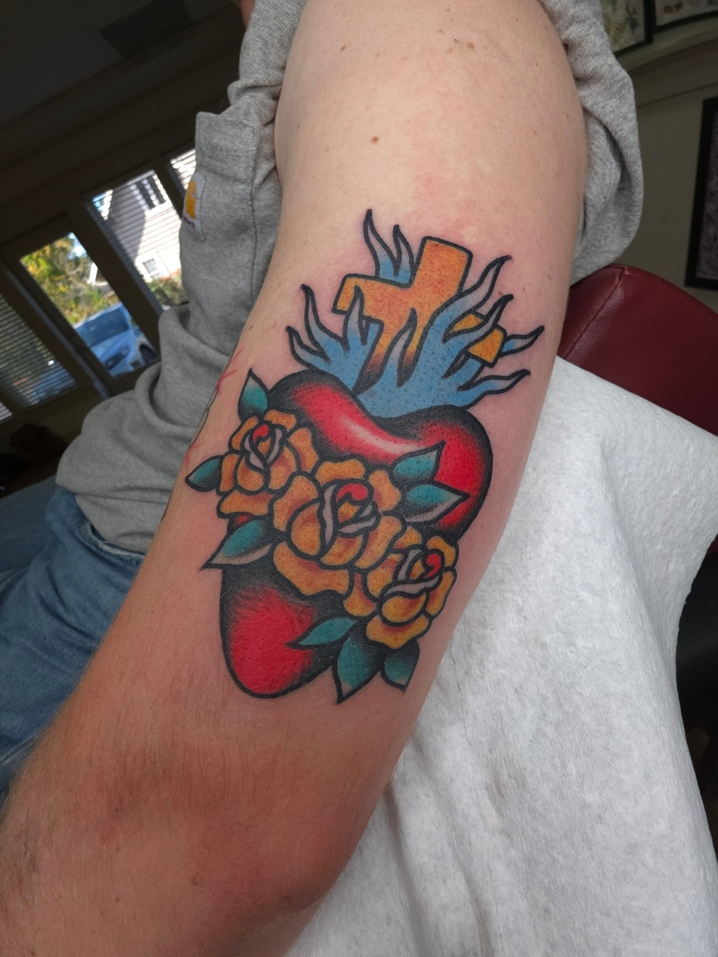 Heart with cross and roses American traditional tattoo on the forearm by Clayton Harpole, Jefferson, Oregon
