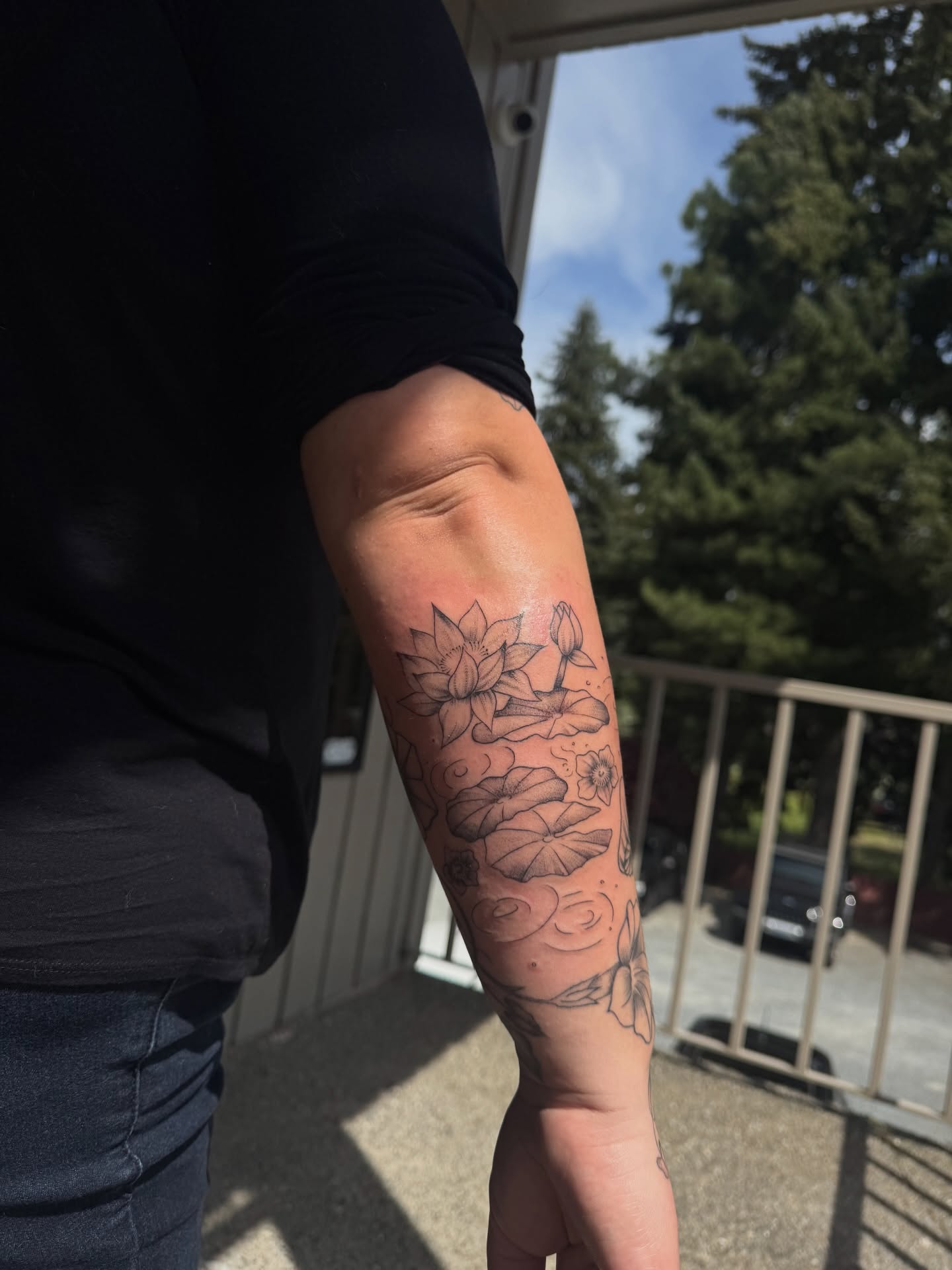 Lotus flowers black and grey tattoo on the forearm by juice🕷tattoo artist