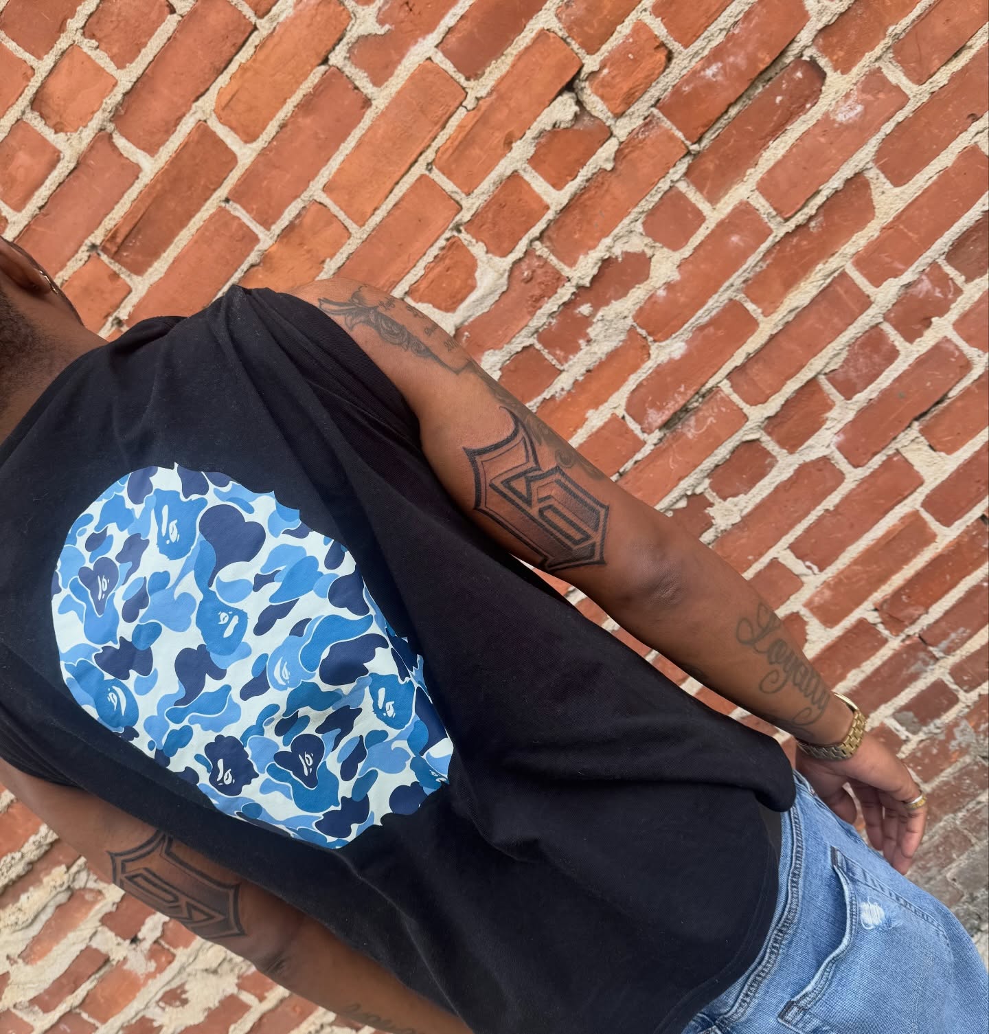 Blue camouflage pattern new school tattoo on the upper arm by Angel Pineda-Rodriguez