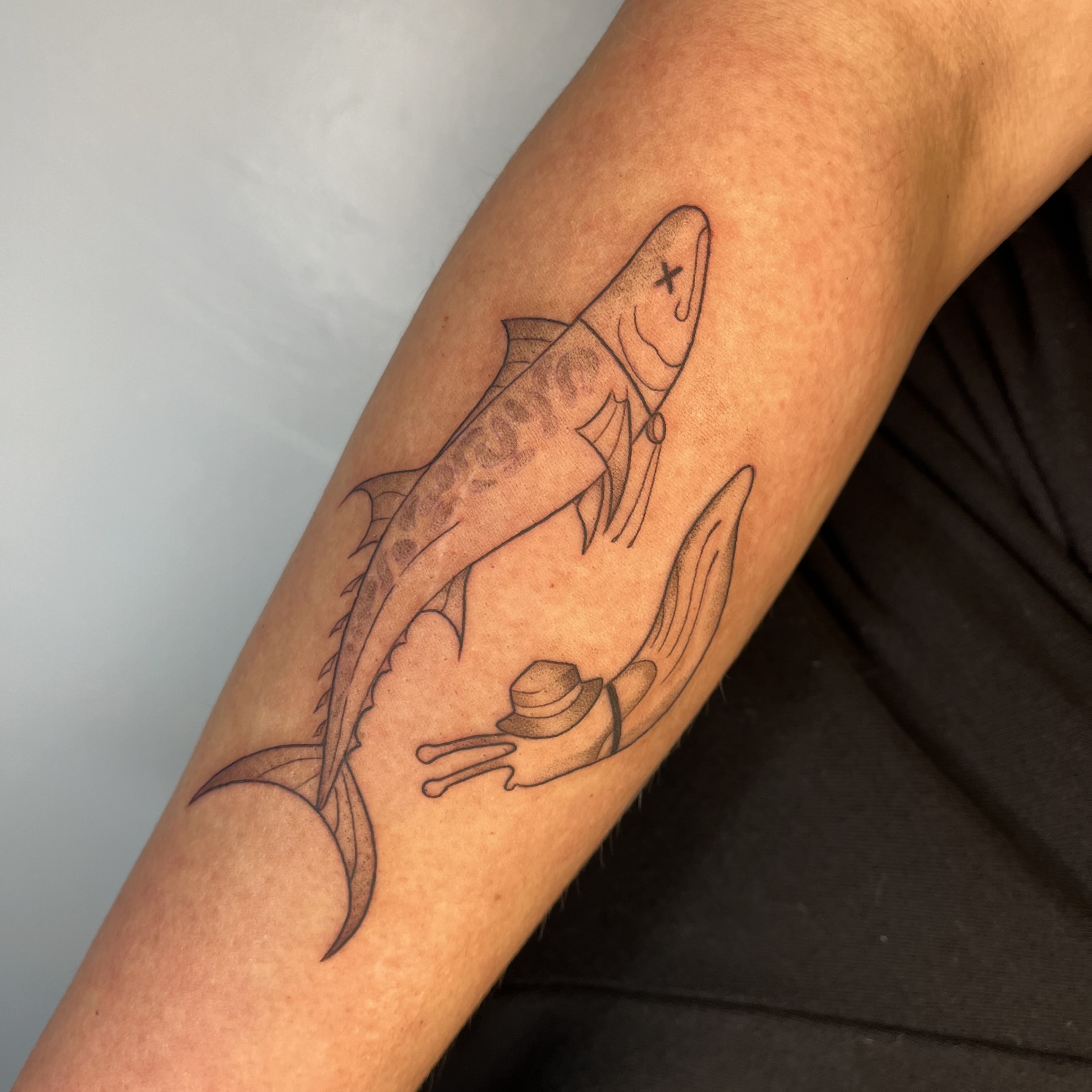 Fish and frog black and grey tattoo on the forearm by Iggy Montgomery (they