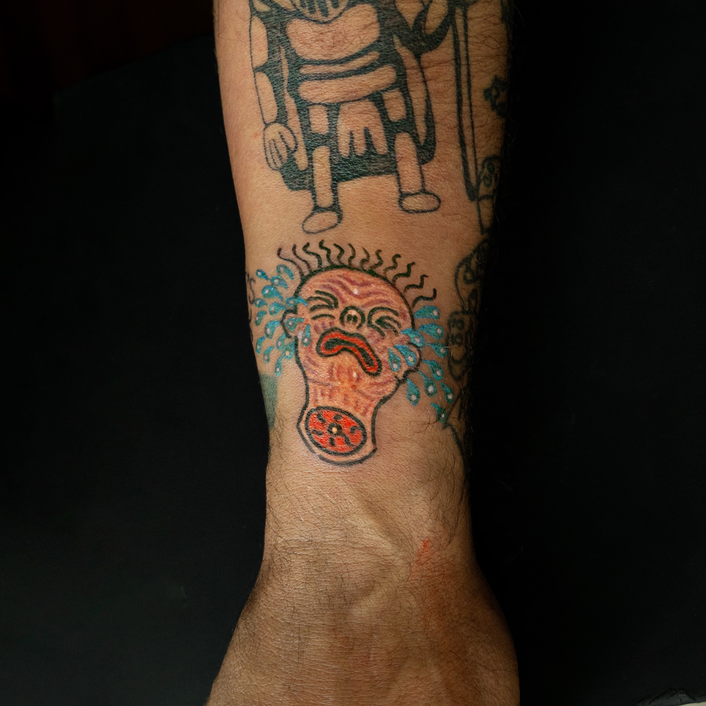 Crying clown American traditional tattoo on the forearm by Flash Boom Bang Tattoo