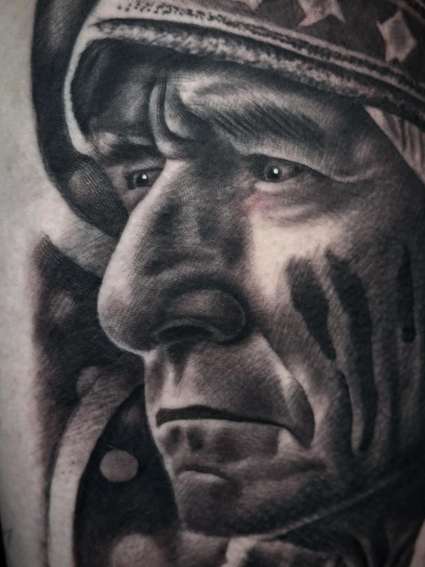 Portrait of a native american man surrealism tattoo on the forearm by Tony Garcia