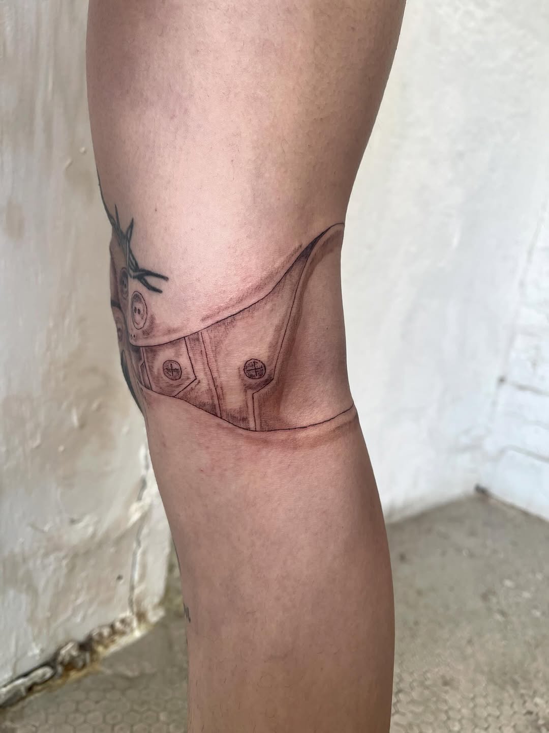 Mechanical knee brace geometric tattoo on the thigh by @initiationoftorture
