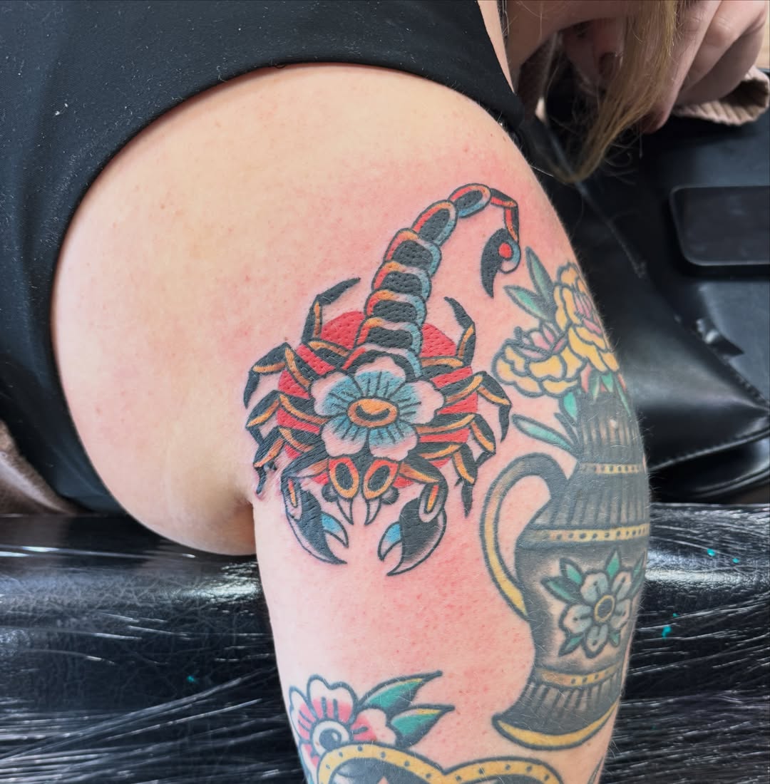 Scorpion and floral bouquet American traditional tattoo on the thigh by Justin Chapman, Des Moines, Iowa