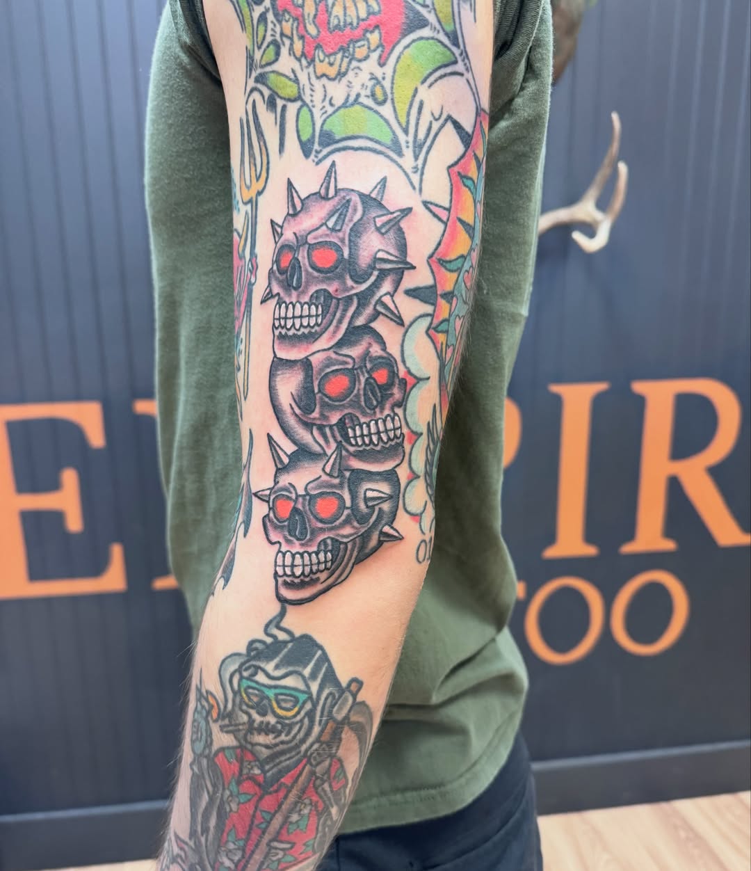 Skulls and roses American traditional tattoo on the forearm by Justin Chapman, Des Moines, Iowa