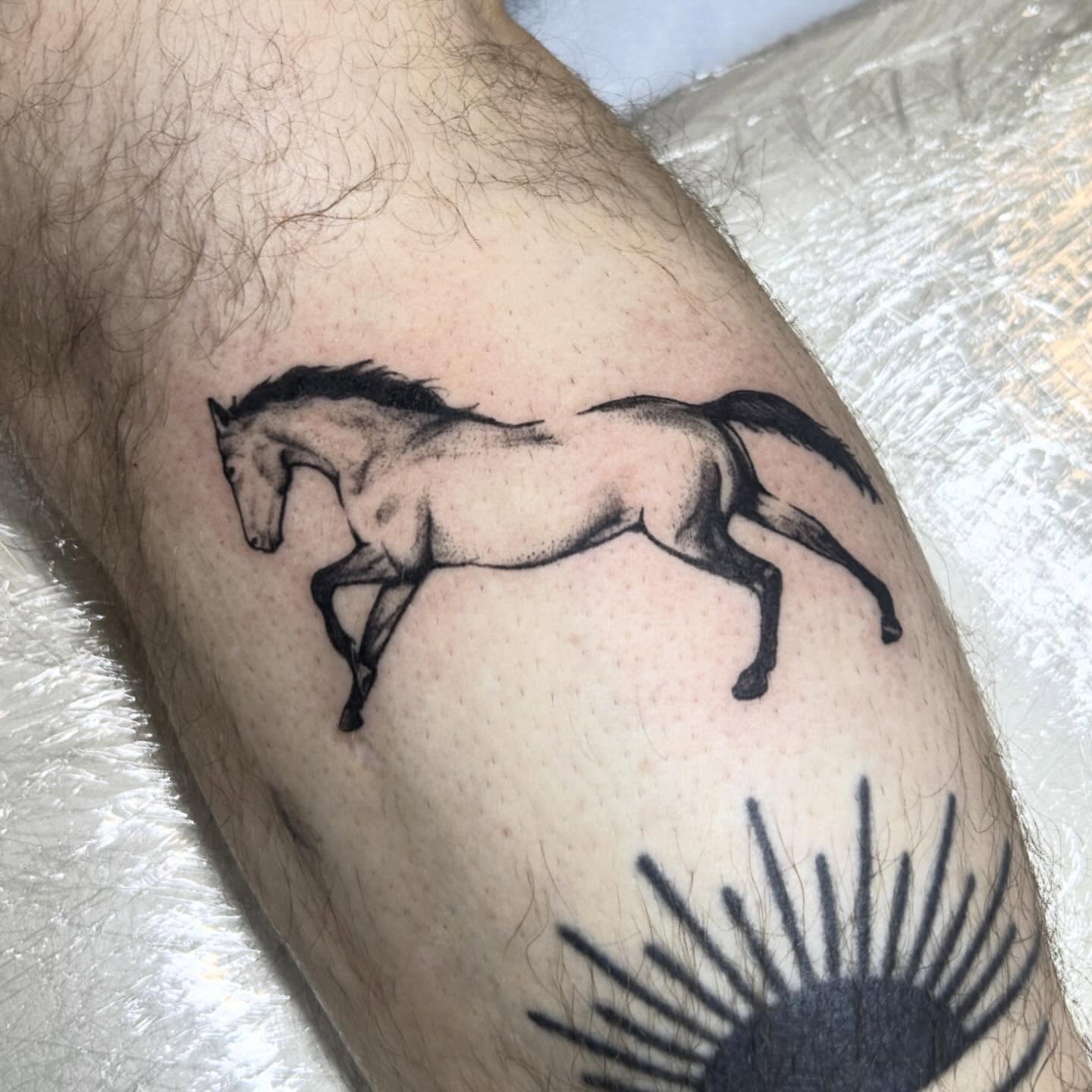 Galloping horse dotwork tattoo on the forearm by Nikki Power