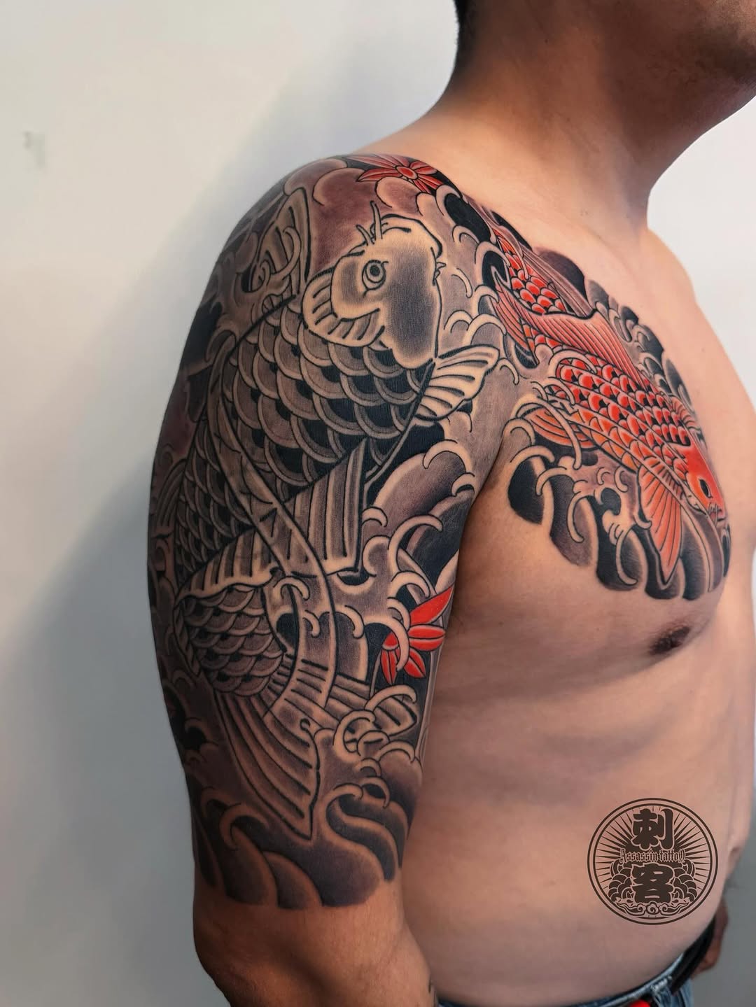 Koi fish and waves Japanese tattoo on the shoulder by Duo