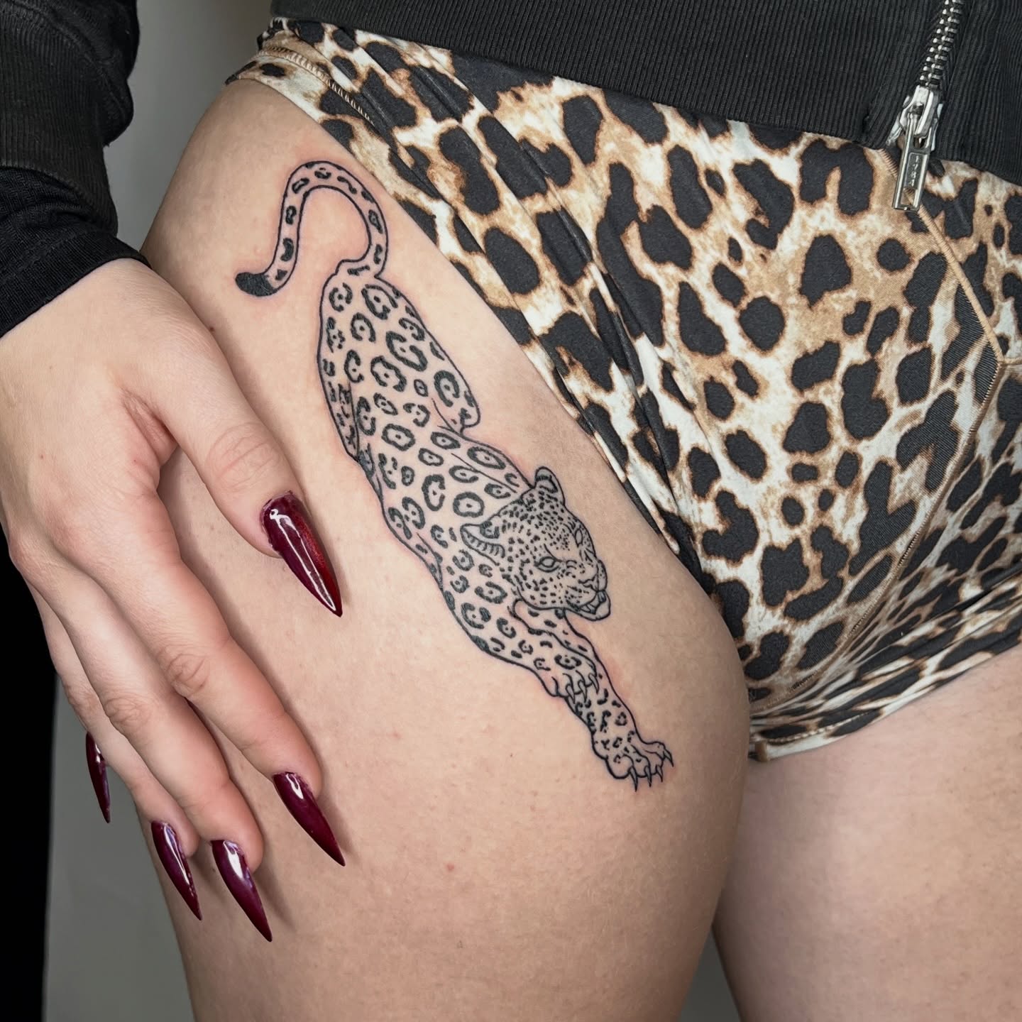 Leopard black and grey tattoo on the thigh by ⚒dptattoos ⚒, East Williamsburg, Brooklyn