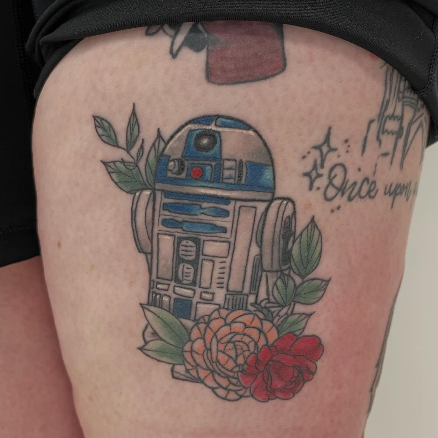 R2-D2 with flowers new school tattoo on the thigh by Kori Millhimes