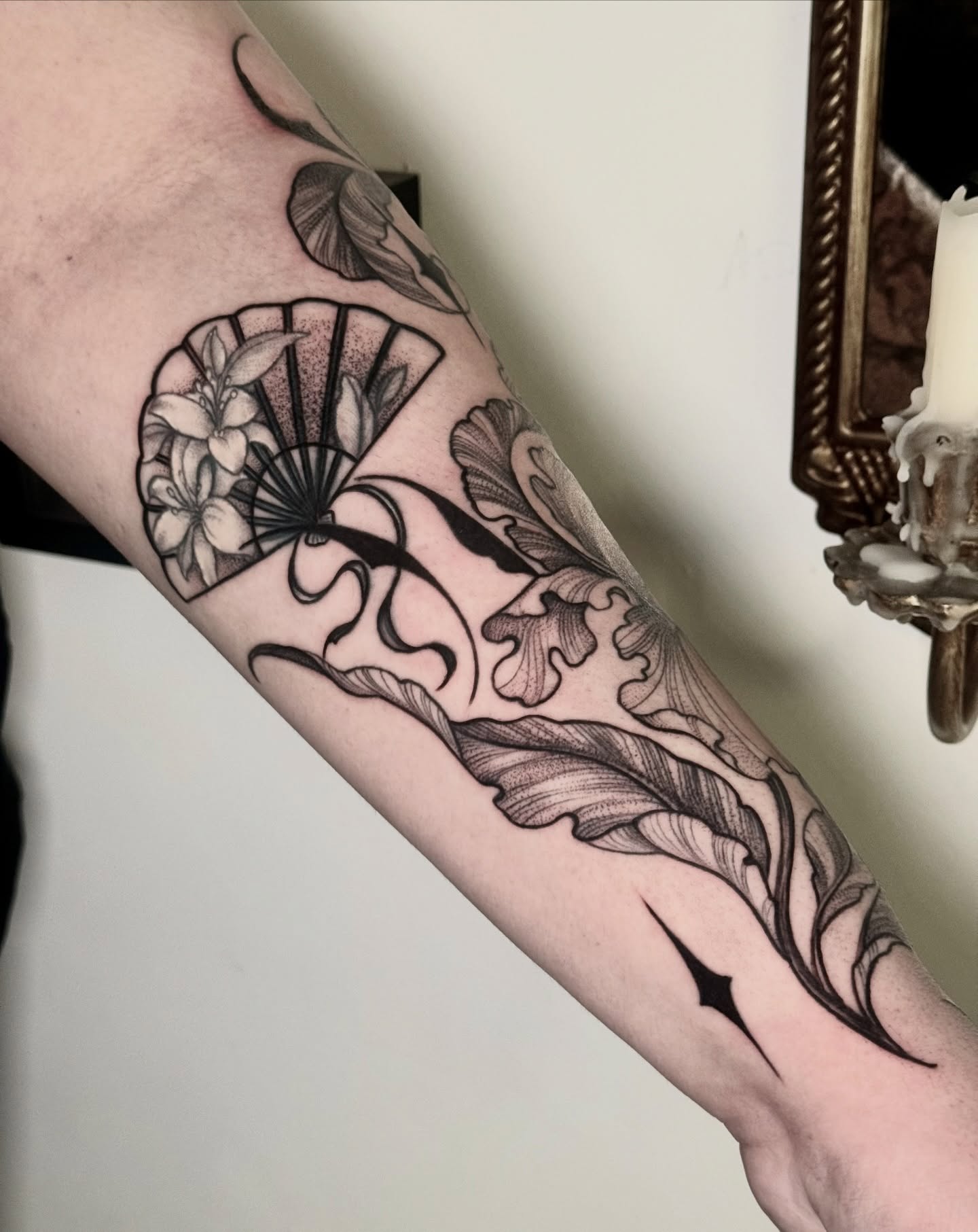 Fan and floral ornamental tattoo on the forearm by ℳ𝒾𝓇𝓉𝒽𝒶 𝒯ℴ𝓇𝓇ℯ𝓈, San Diego, California