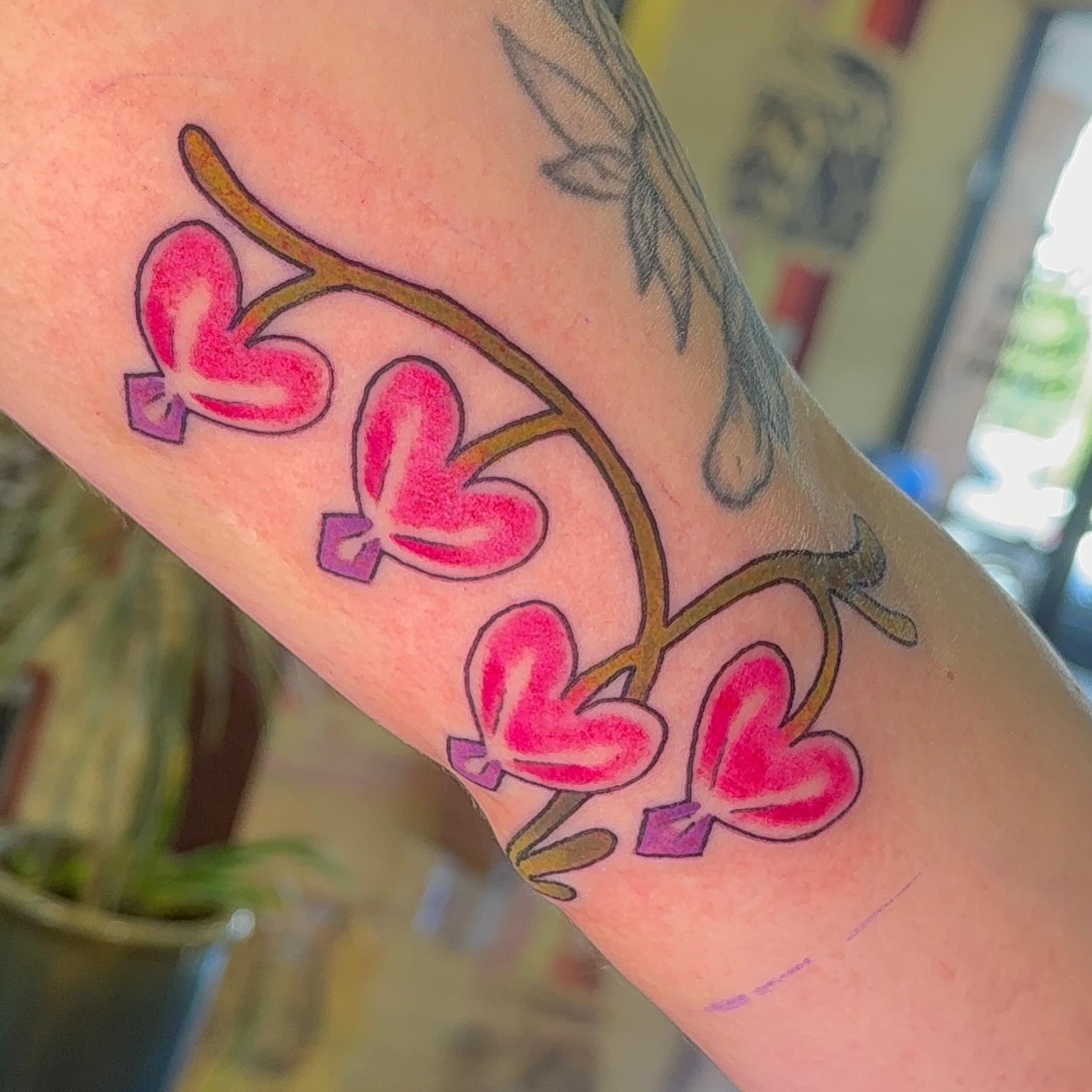 Heart-shaped butterflies new school tattoo on the forearm by Erin McDavis