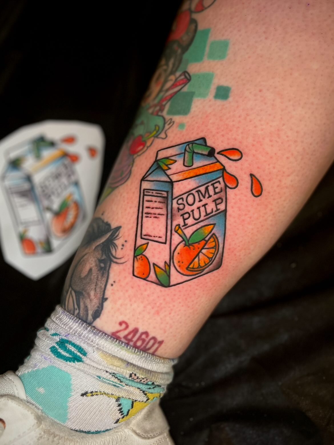 Orange juice carton new school tattoo on the forearm by Nick Andrade Las Vegas Tattoo Artist