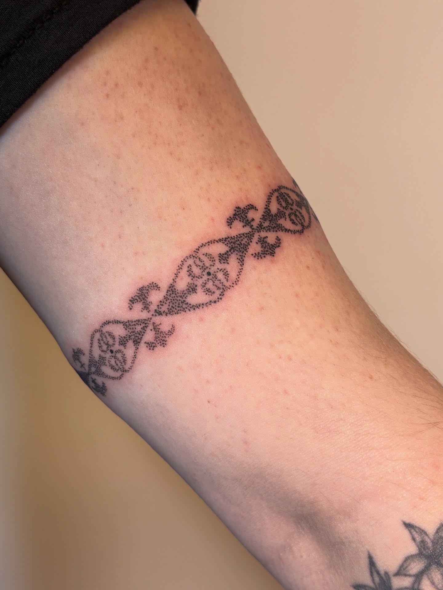 Scrollwork dotwork tattoo on the forearm by Maddie