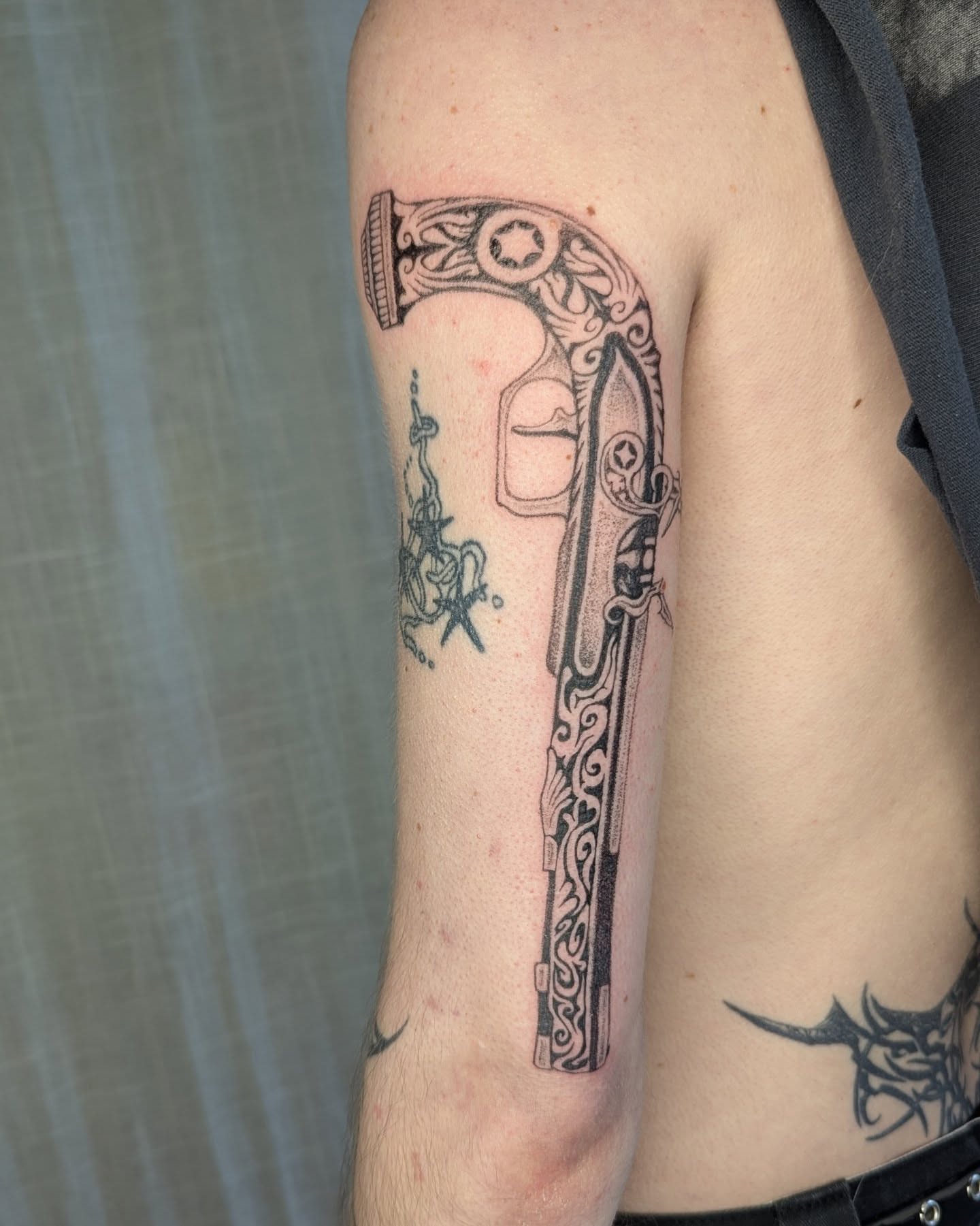 Gun black and grey tattoo on the forearm by theo, Portland, Oregon