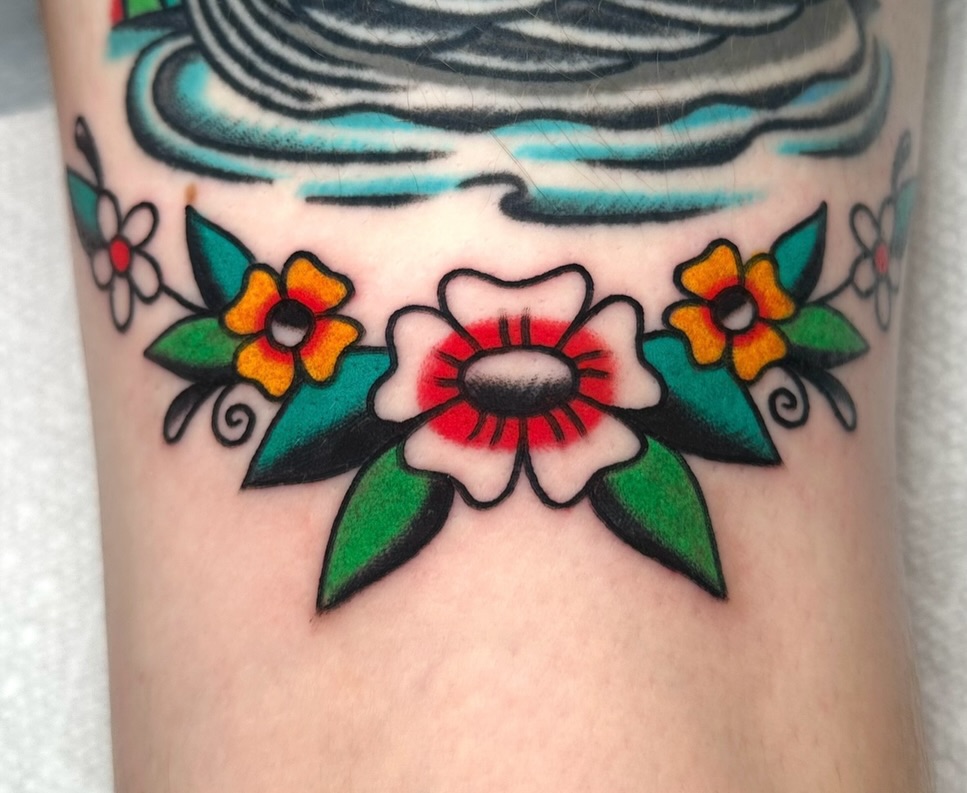 Flowers American traditional tattoo on the forearm by Zahra Niedermann