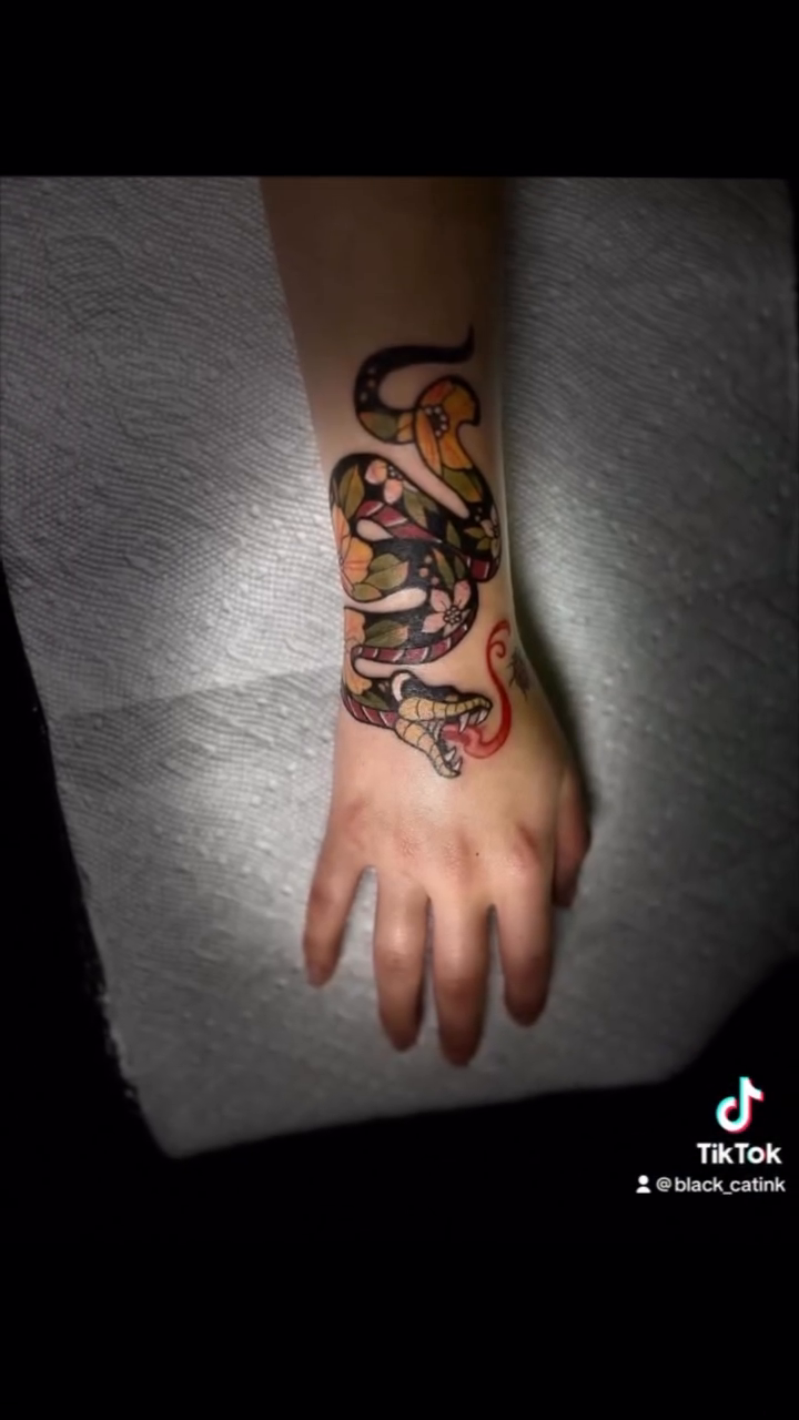 Snake American traditional tattoo on the forearm by Christhian King