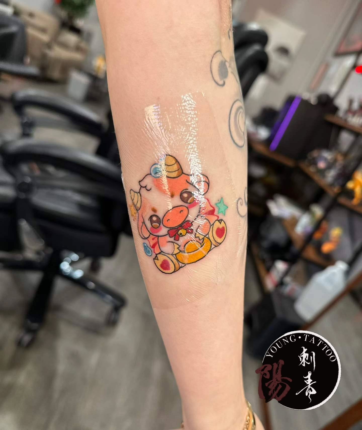 Cow new school tattoo on the forearm by Ying