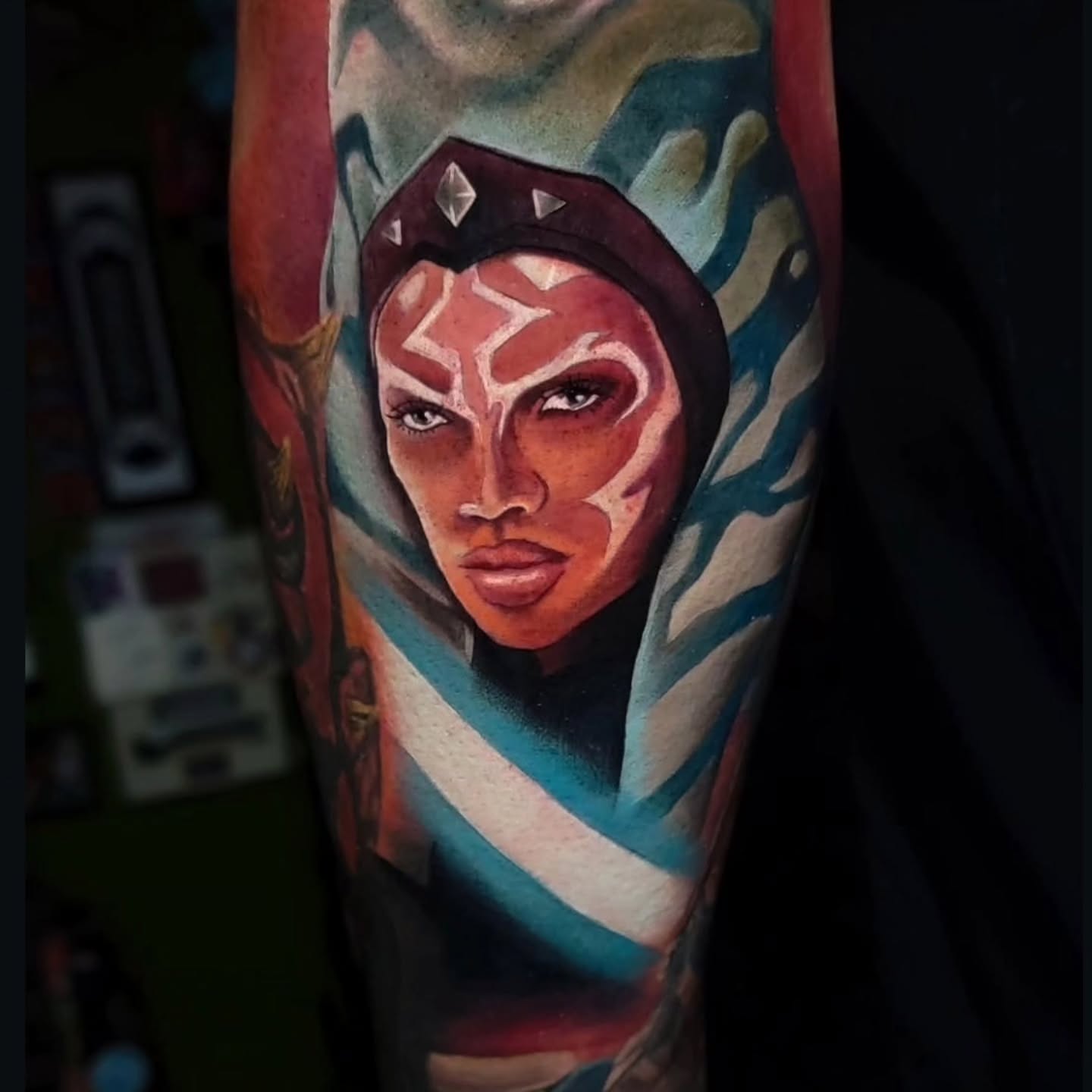 Woman with star face paint realism tattoo on the forearm by Melissa Does Tattoos - Bright, Bold Anime &