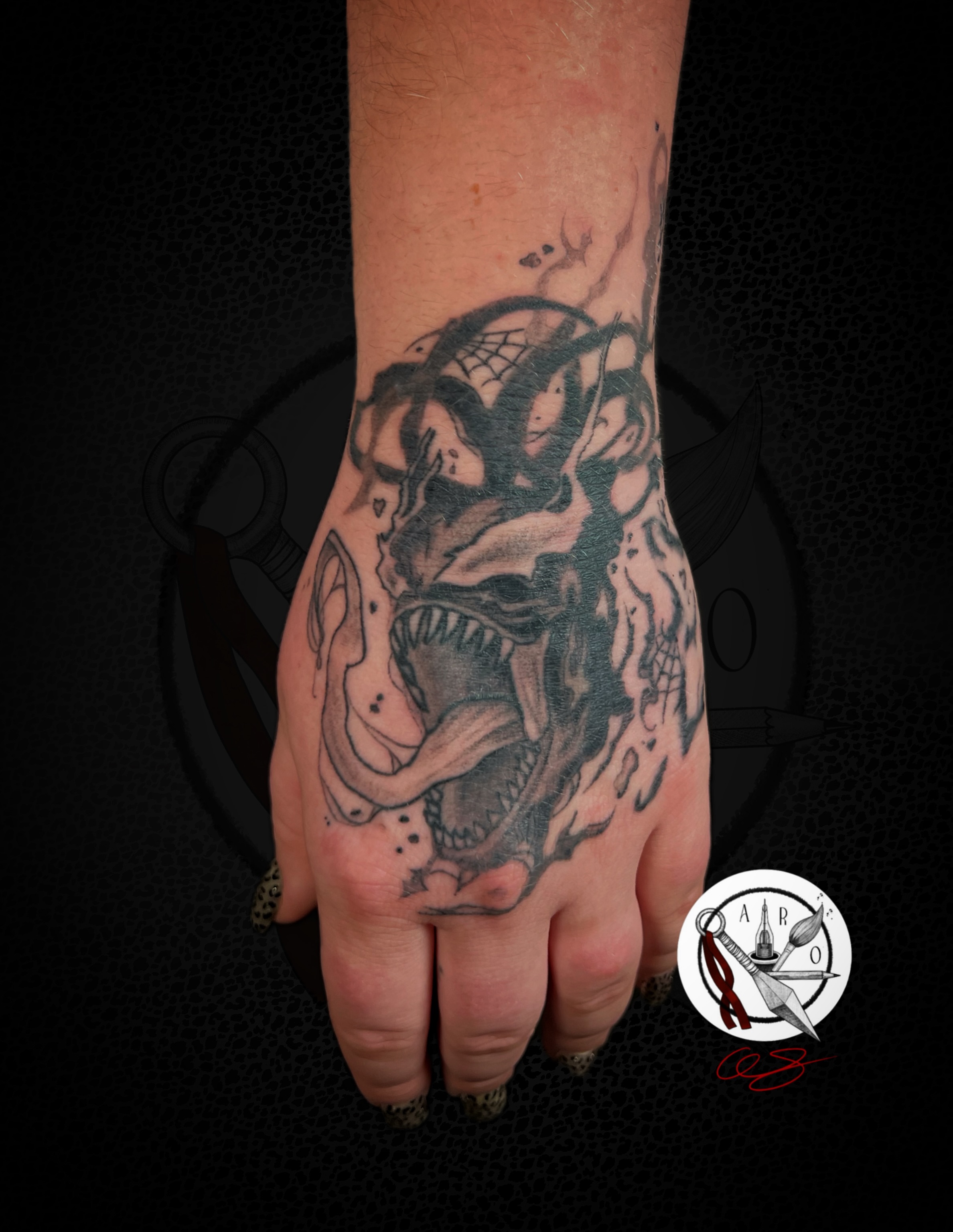 Demon skull dark realism tattoo on the hand by Aaron Strobehn