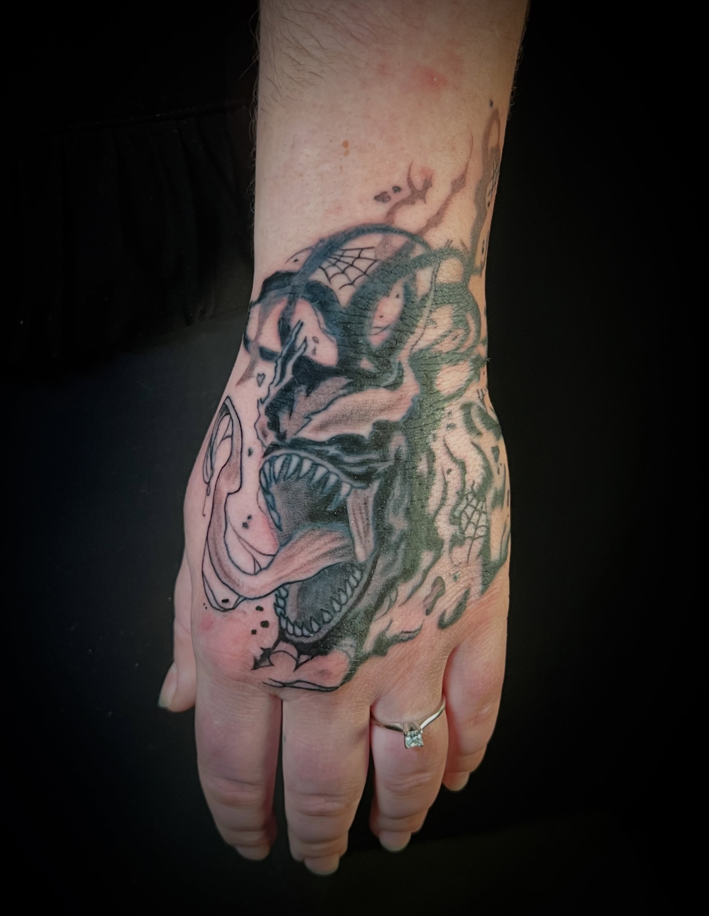 Skull and snake American traditional tattoo on the hand by Aaron Strobehn