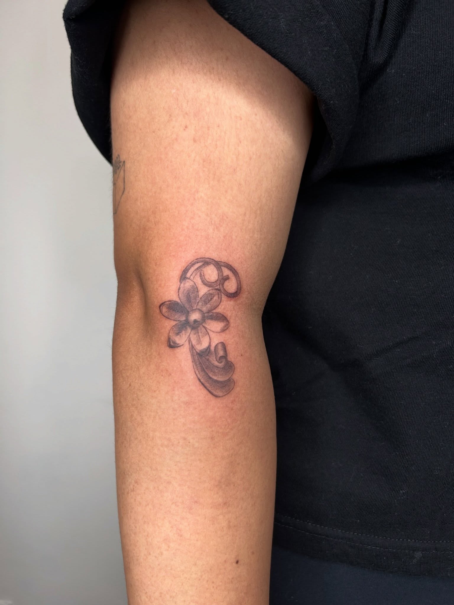 Flower black and grey tattoo on the forearm by beth