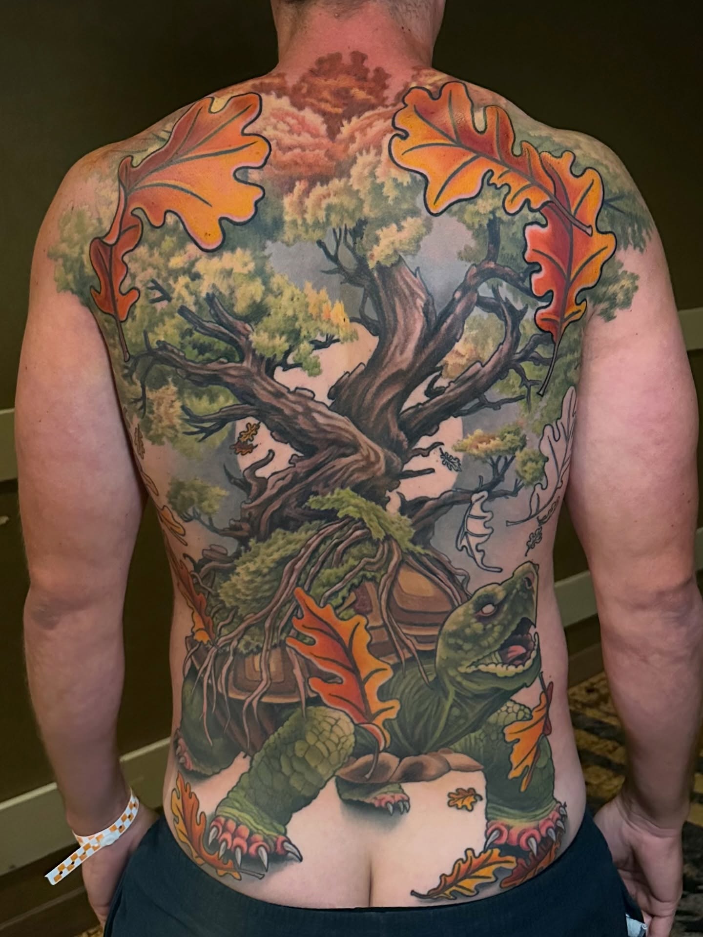 Forest scene with turtle realism tattoo on the back by Trevor Burtz