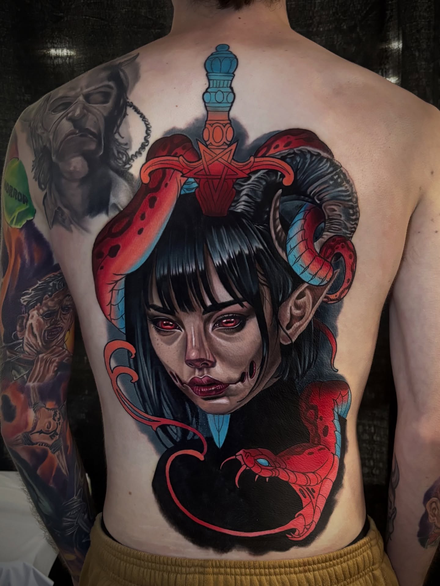 Woman with horns and snake dark realism tattoo on the back by Joshua Orville Vaughn, Kansas City, Missouri