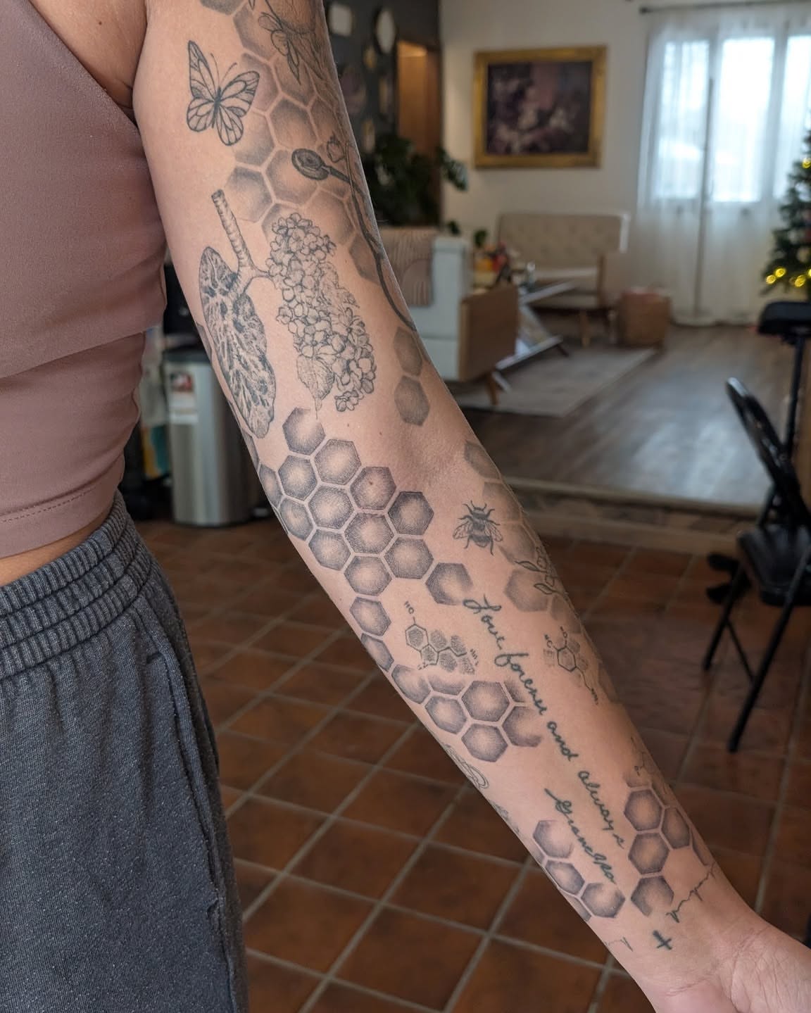 Honeycomb pattern geometric tattoo on the forearm by Arminda Walborn