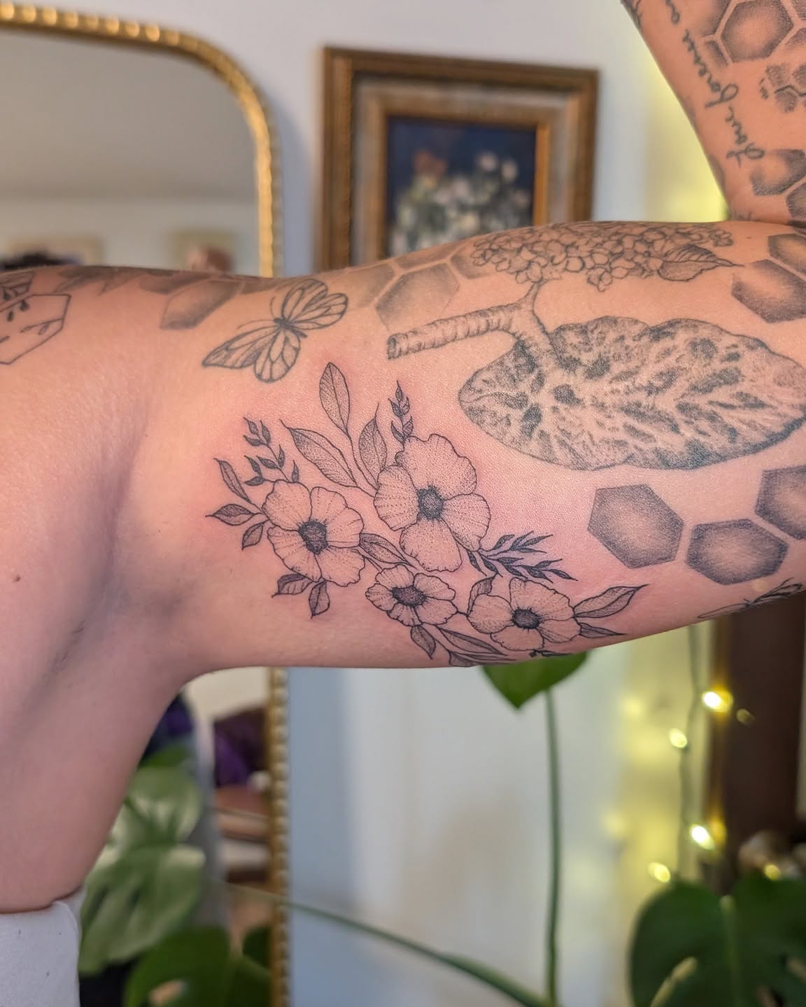 Flowers and leaves black and grey tattoo on the forearm by Arminda Walborn