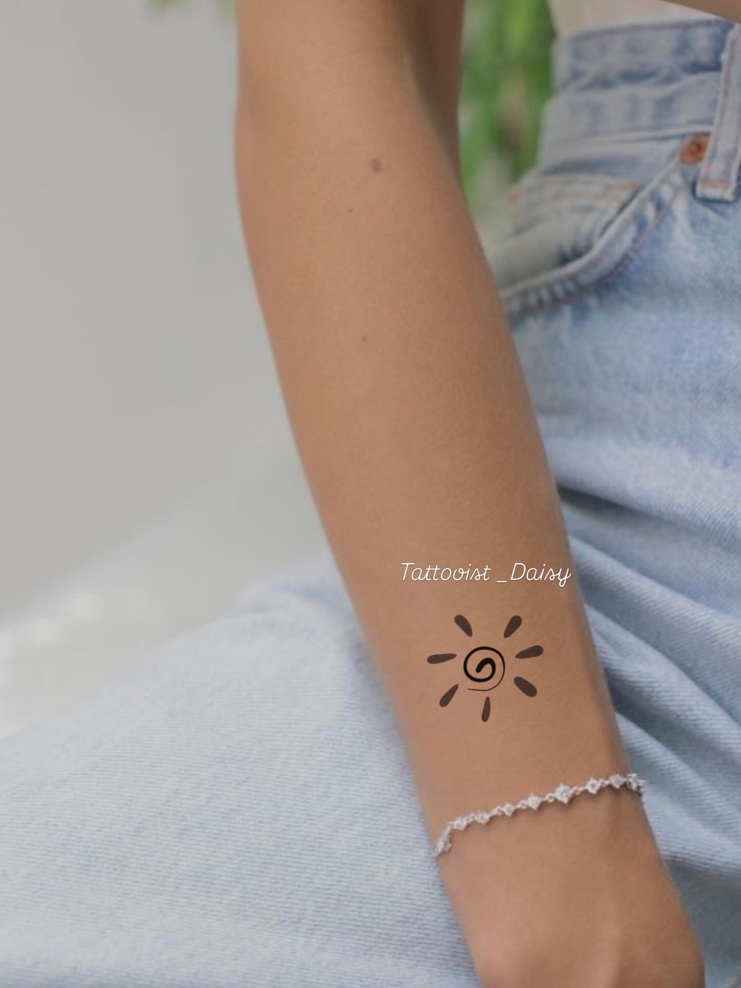 Sun spiral minimalist tattoo on the forearm by Ink _daisy_
