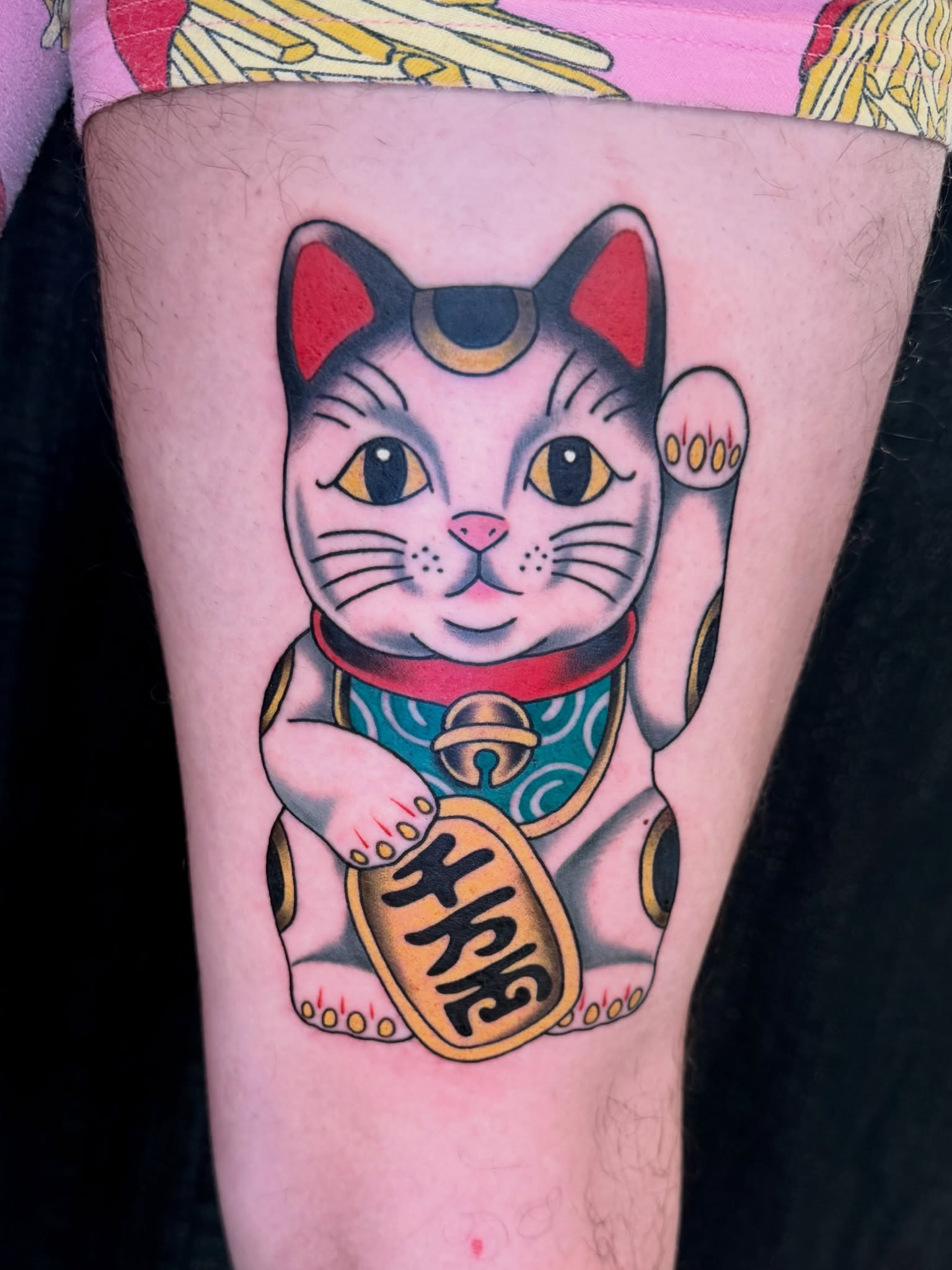 Maneki-neko American traditional tattoo on the forearm by Savannah Compton