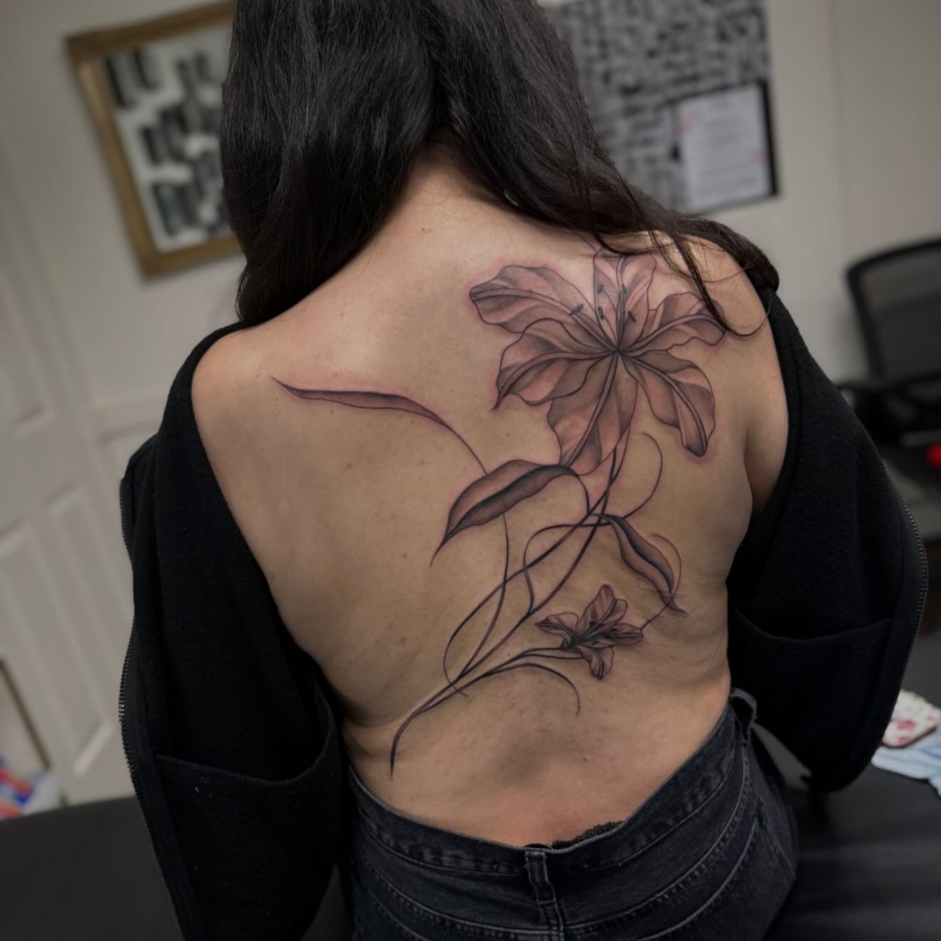 Flower black and grey tattoo on the back by Sad Girl Tattoos