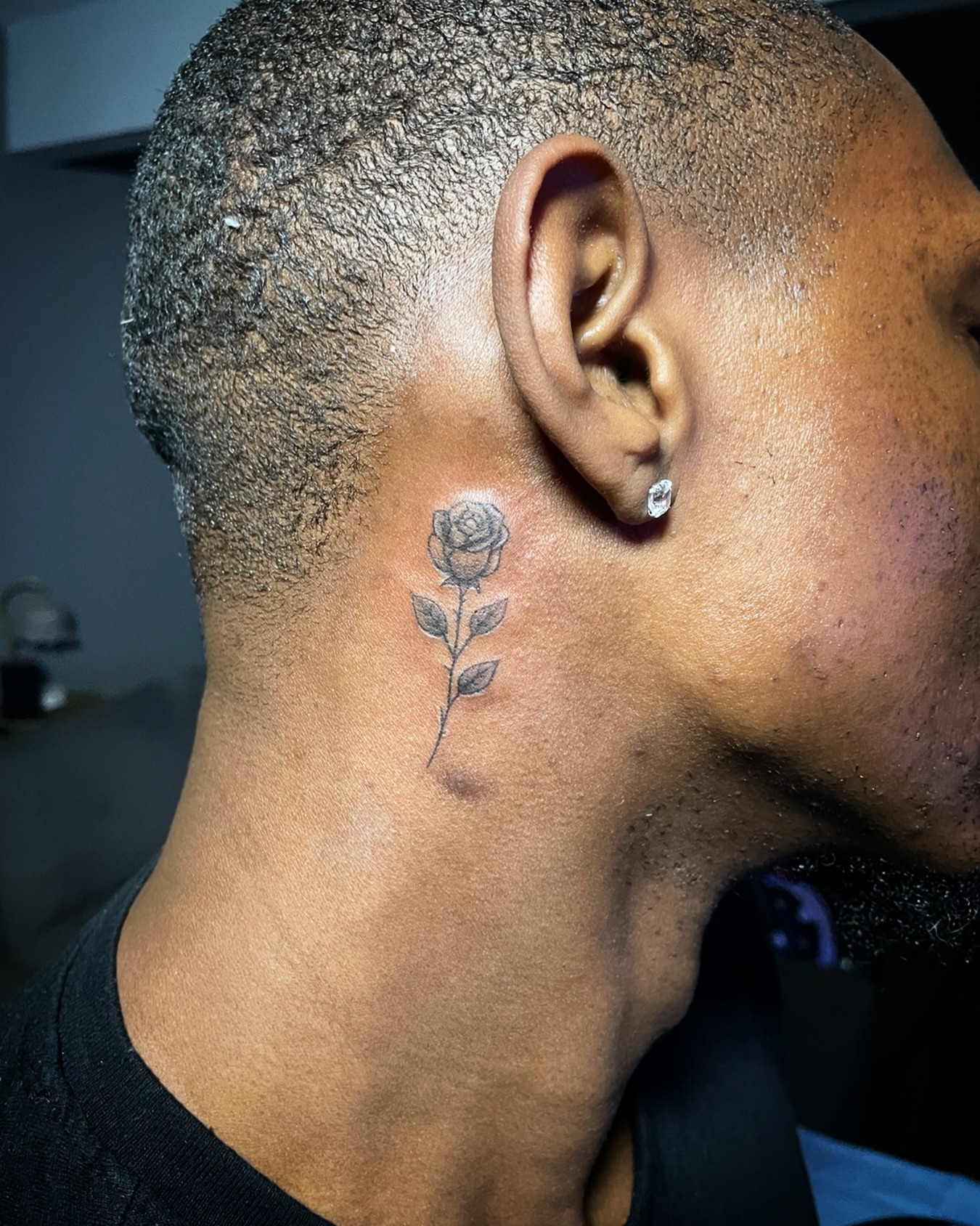 Rose black and grey tattoo on the neck by The Reelist Ink