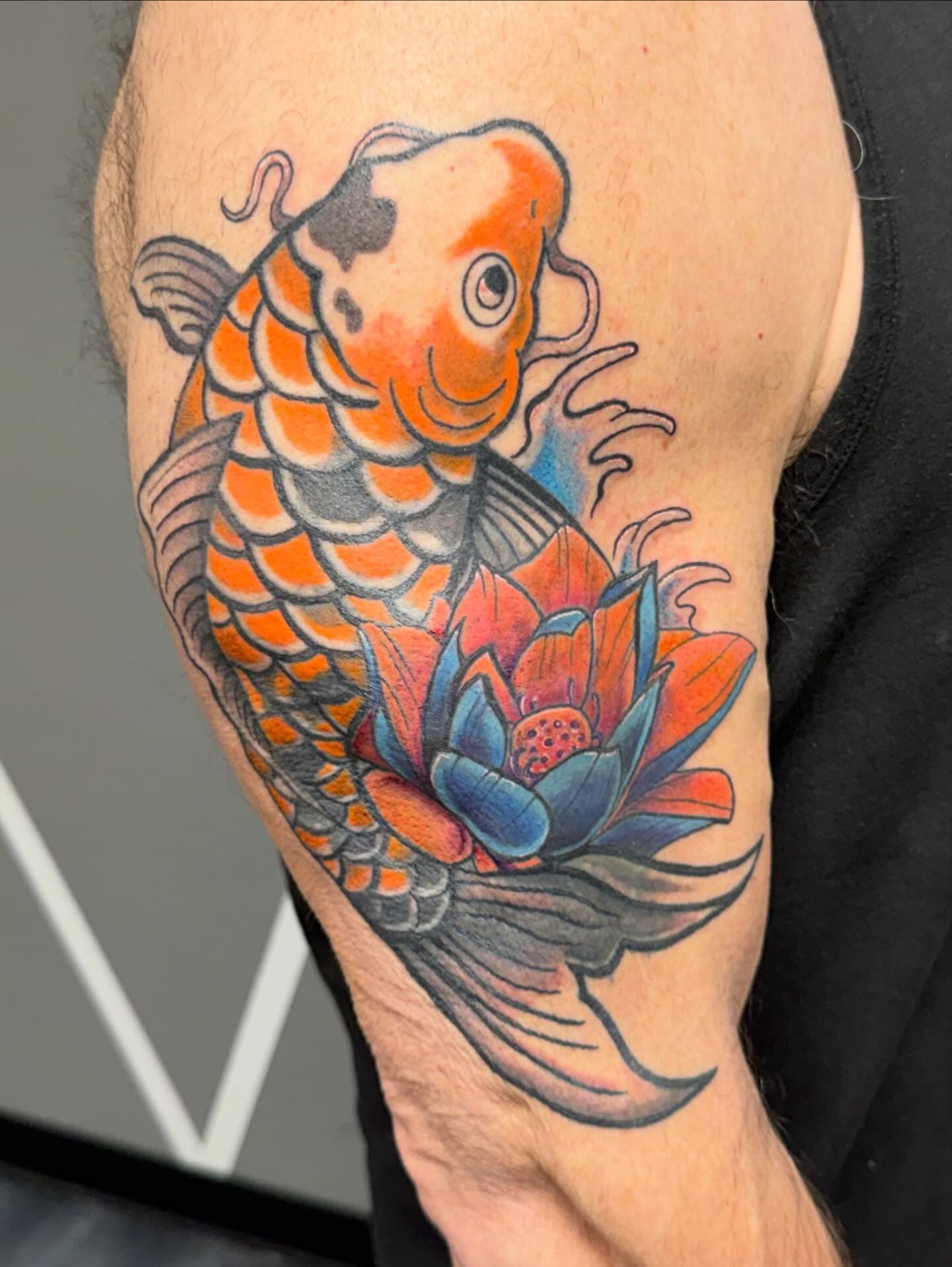 Koi fish and lotus flower japanese irezumi tattoo on the forearm by Katie Rojas