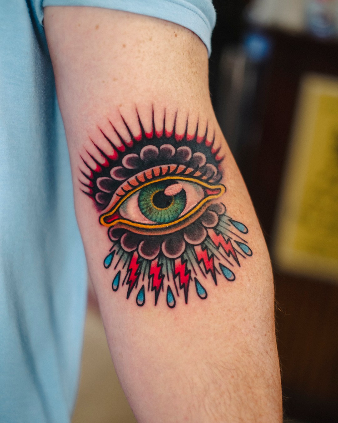 Eye with lightning bolts American traditional tattoo on the forearm by Dan Gilsdorf, Portland, Oregon