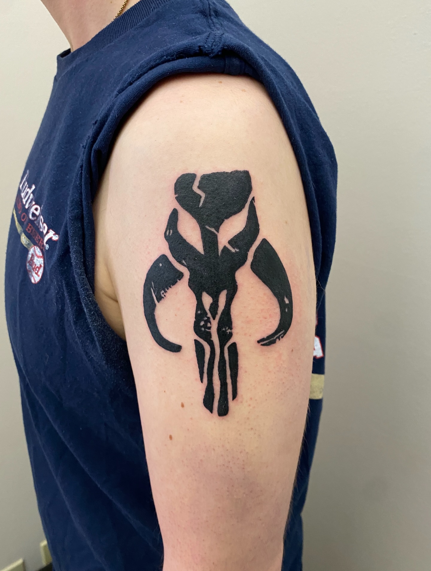 Mandalorian symbol black and grey tattoo on the shoulder by Aidan Leery, Portland, Oregon