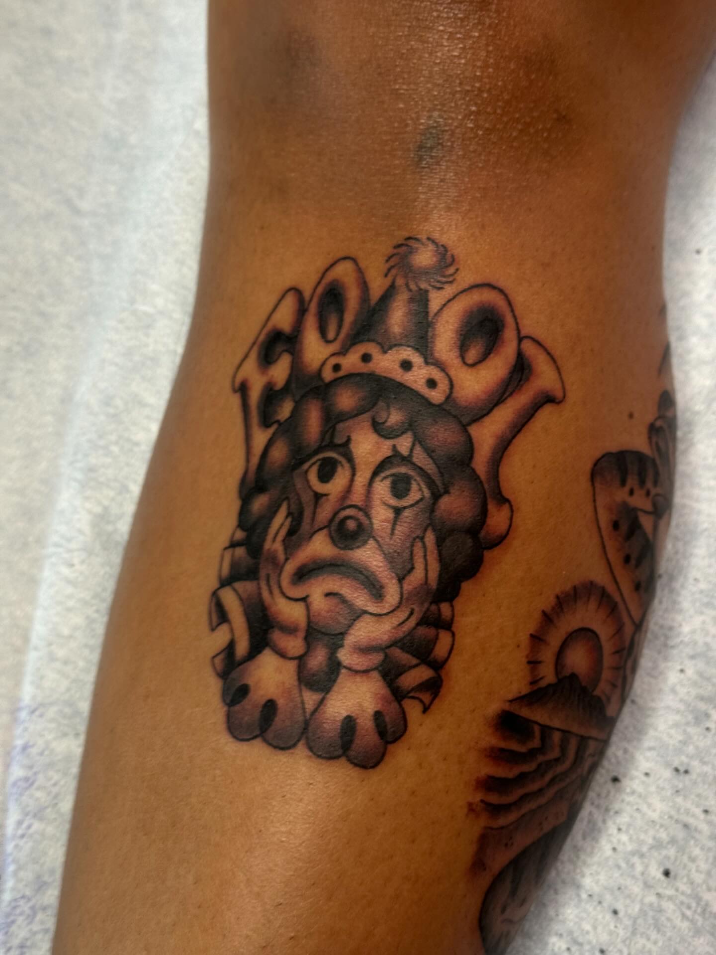 Jester crown black and grey tattoo on the forearm by B