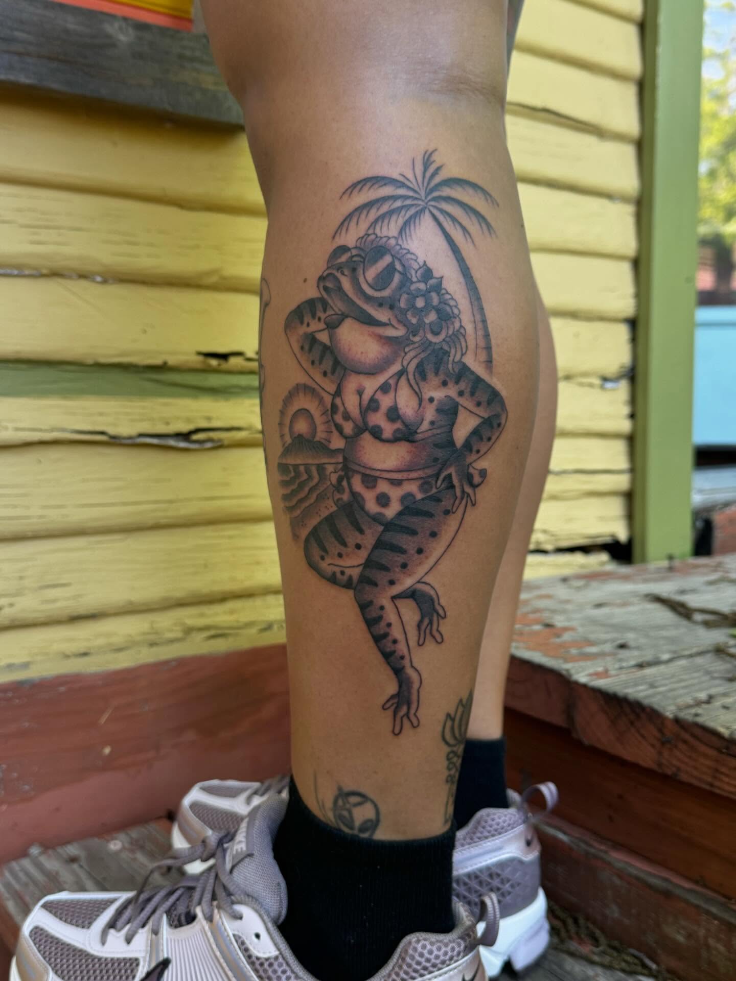 Frog in bikini black and grey tattoo on the calf by B