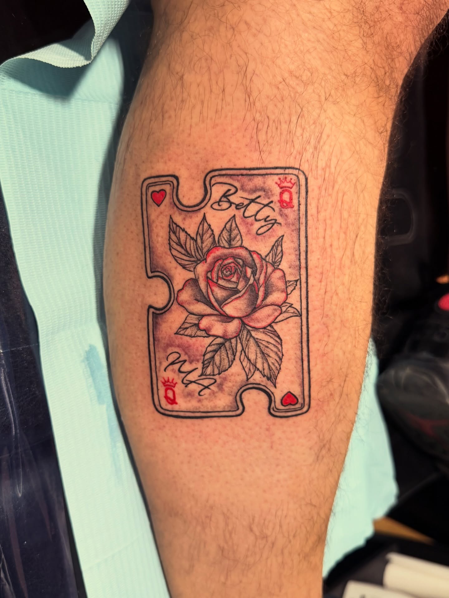 Playing card with rose black and grey tattoo on the thigh by CandiCoatedInk