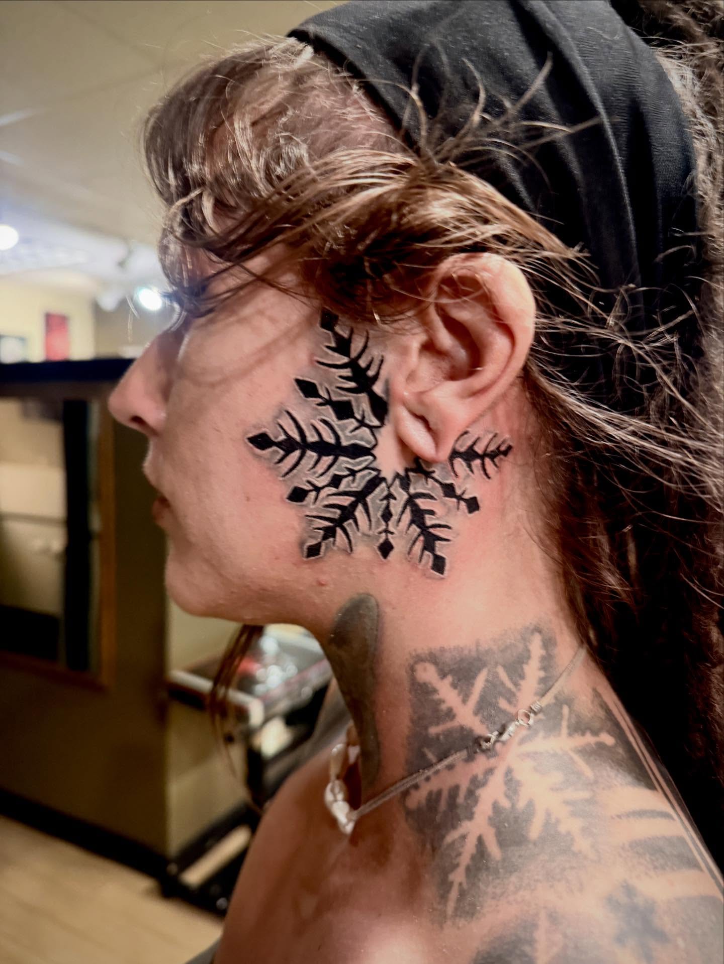 Snowflake black and grey tattoo on the neck by Patrick Delvar