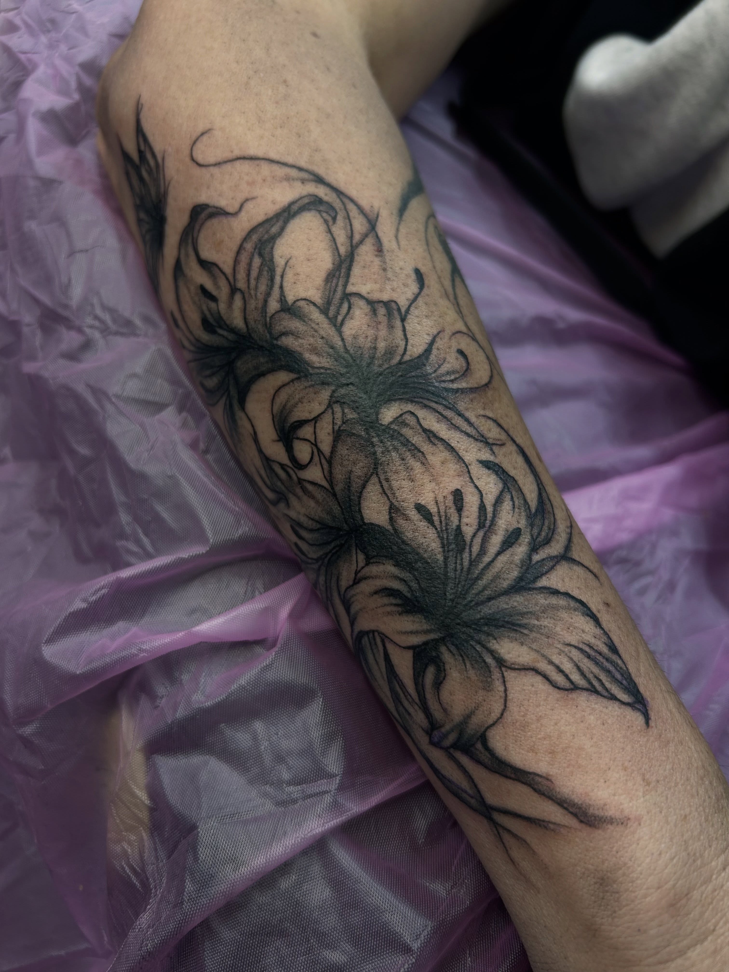 Flowers black and grey tattoo on the forearm by Amara Lyons, Matakana, New Zealand