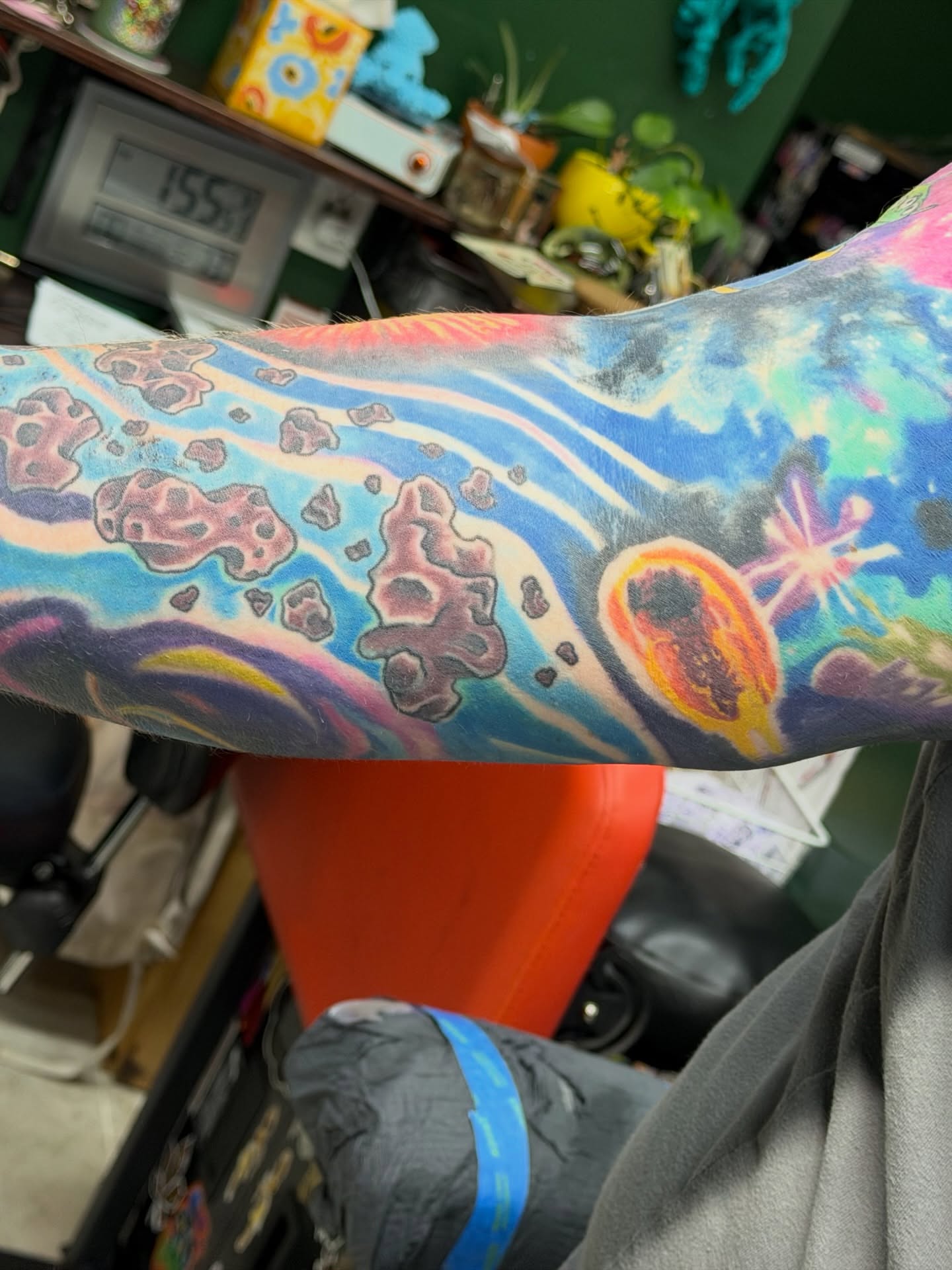 Space scene new school tattoo on the forearm by Squid