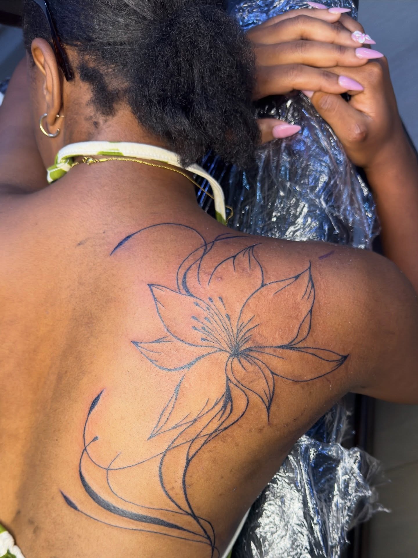Lily fine line tattoo on the back by David Yancy III