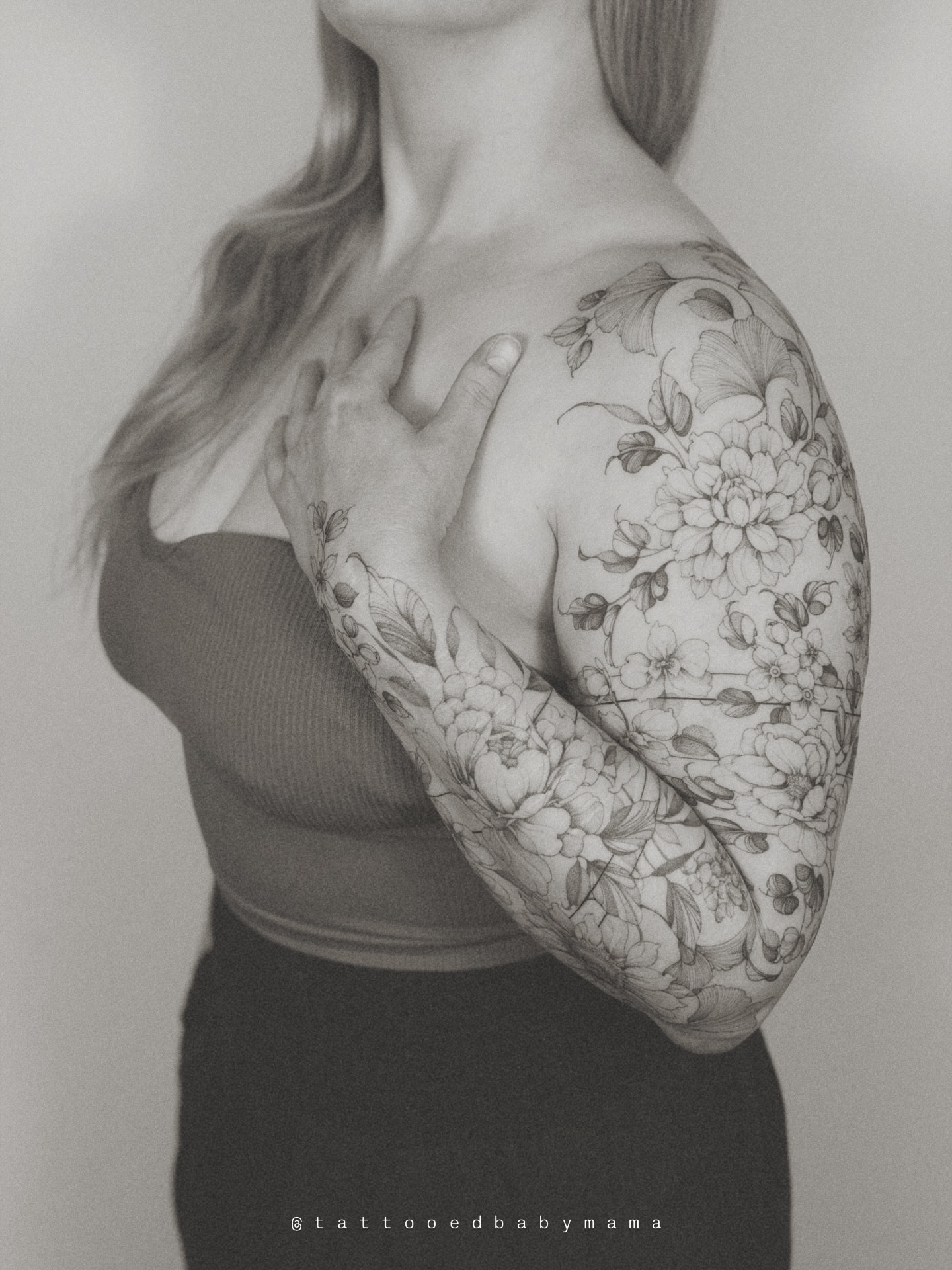 Floral bouquet black and grey tattoo on the upper arm by Andrea Evangelista